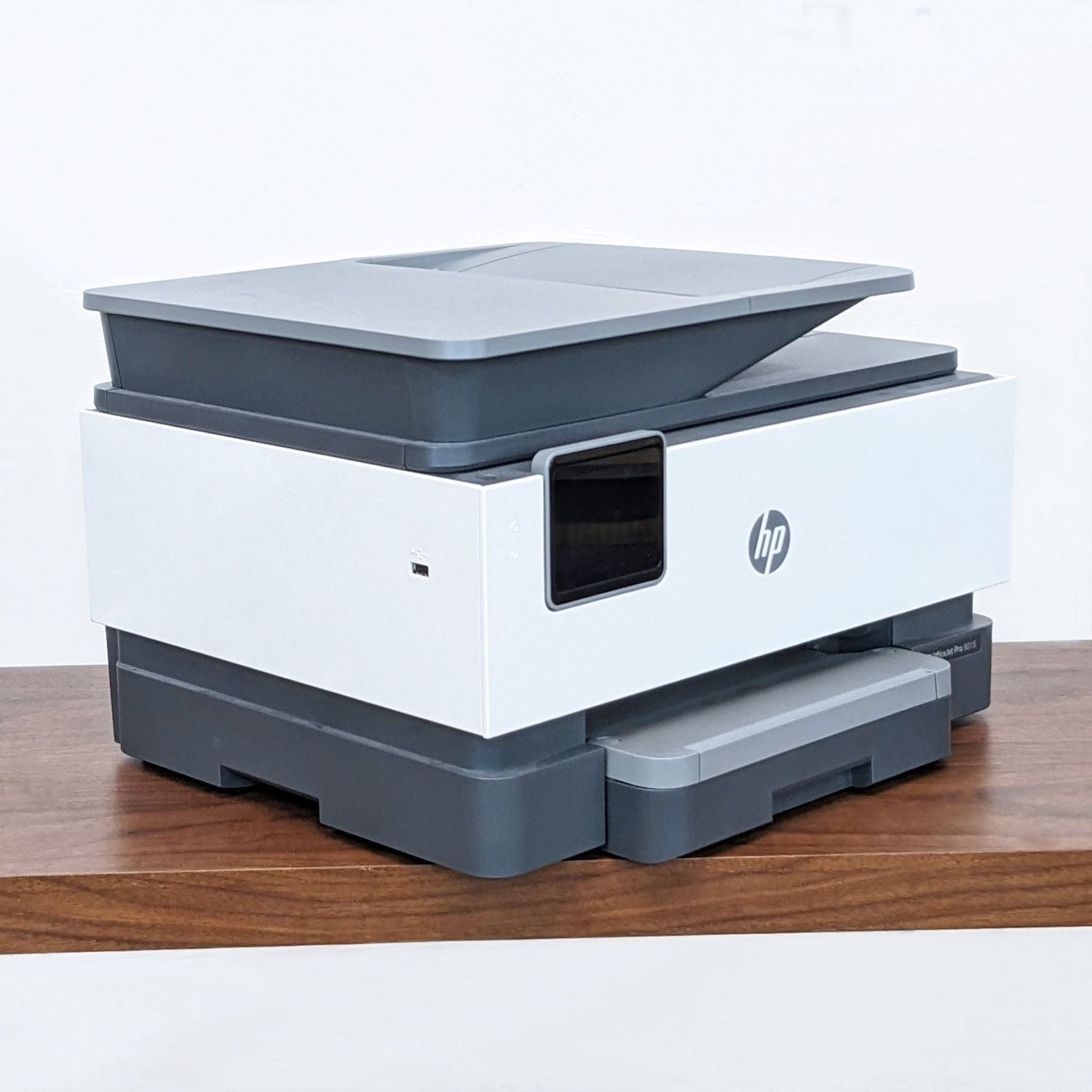HP OfficeJet Pro 9015 printer viewed from the front, paper tray extended, ready for use.