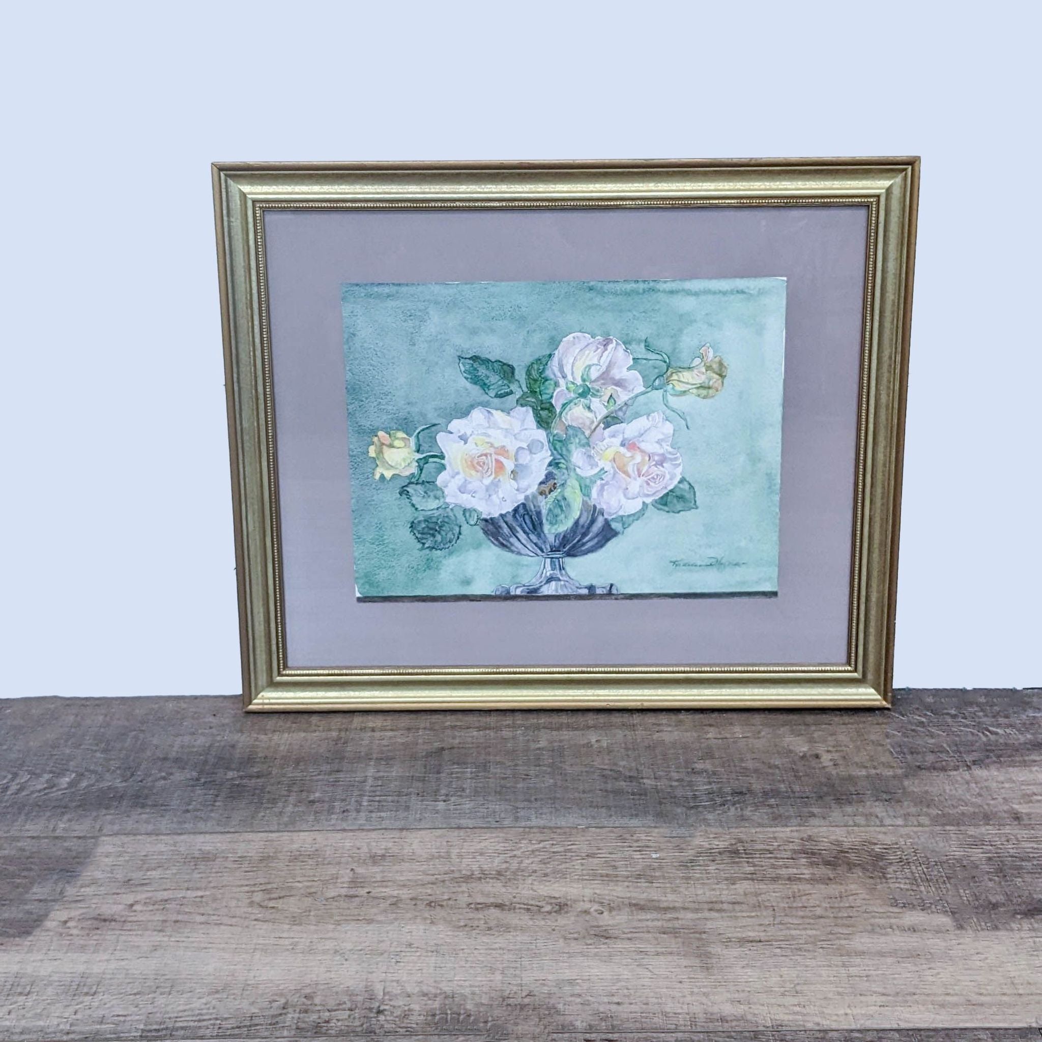 Alt text 1: Reperch brand framed watercolor painting by Kathleen Hynes, depicting soft pastel floral arrangement, displayed on a wooden surface.