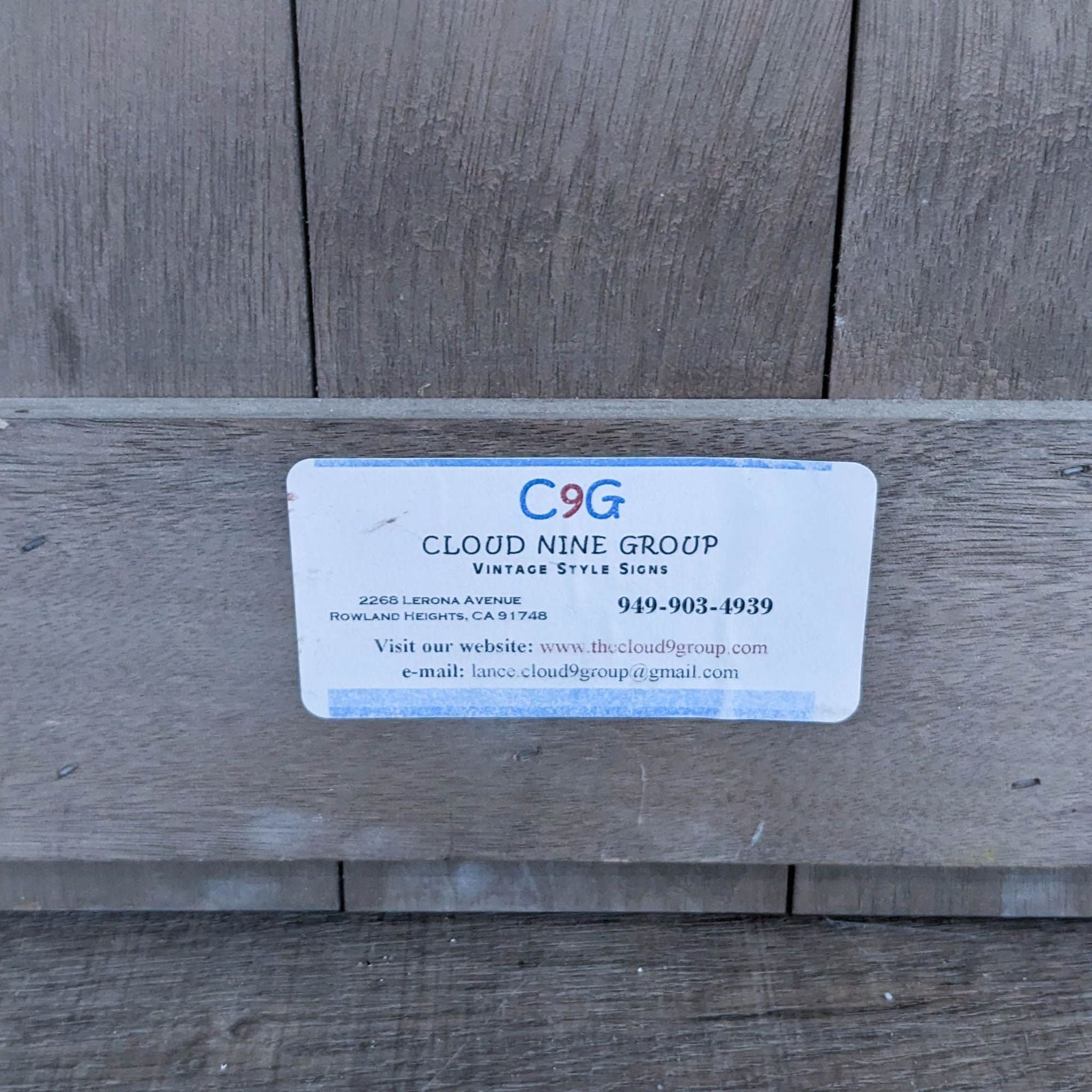 Business card for Cloud Nine Group on a wooden background.
