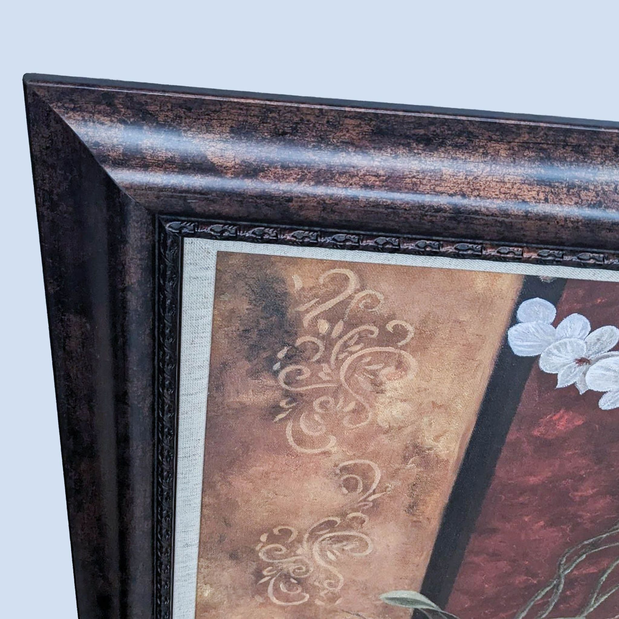 Close-up of a Reperch framed art print showing intricate floral and pattern details within a dark textured frame against a wooden backdrop.