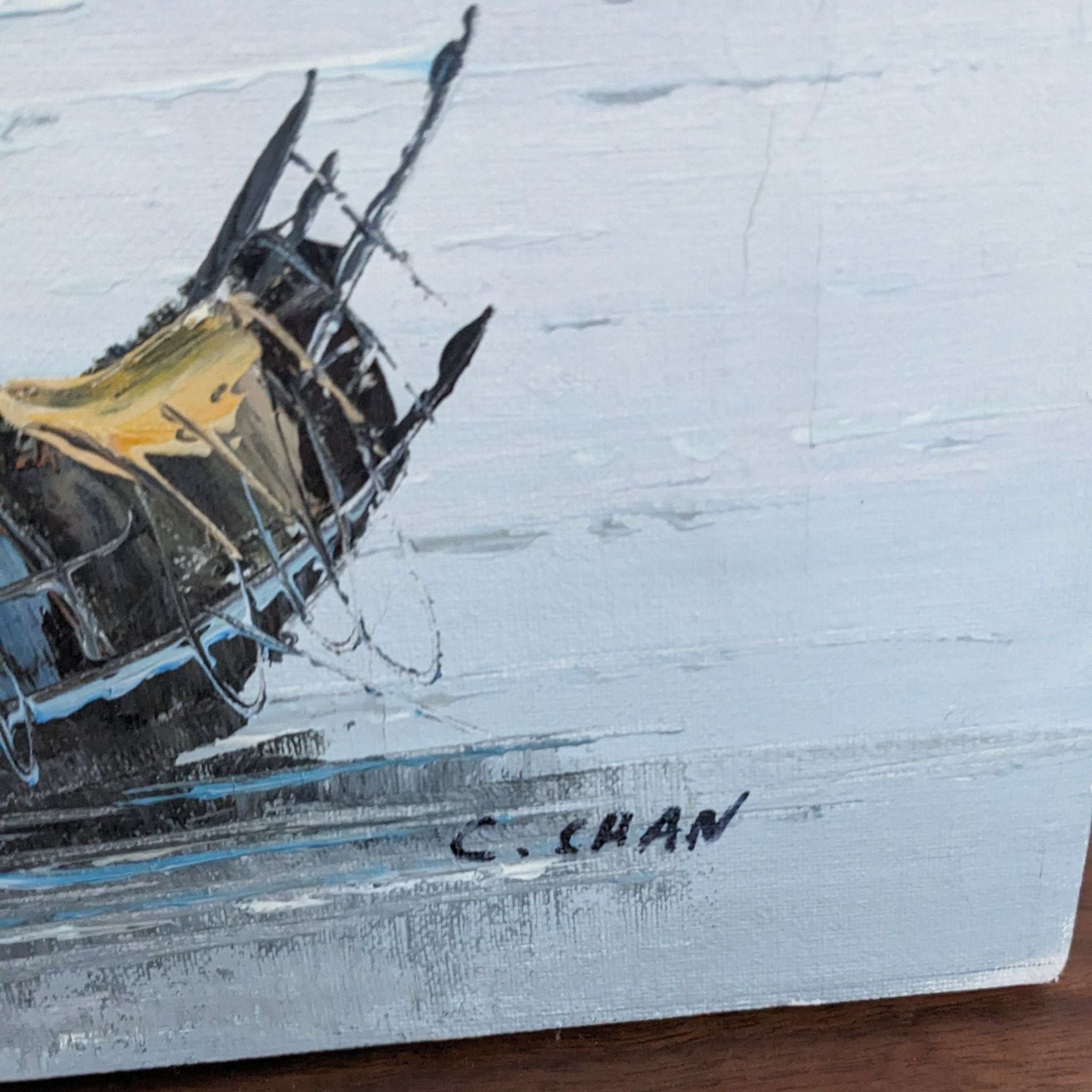 Painting close-up showing a sailboat with artist's signature 'C. Chan', by Reperch, against a pale backdrop.