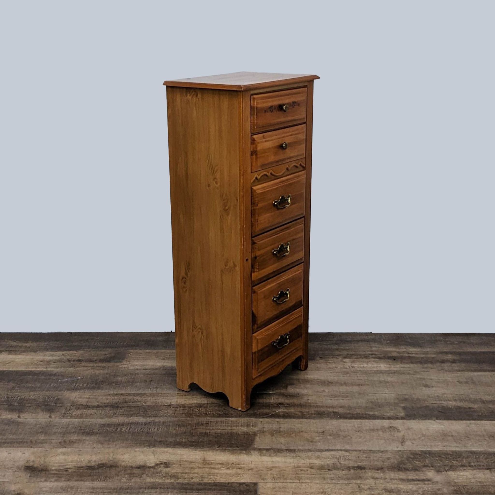 Side view of a Broyhill tallboy dresser, showcasing its compact shape and wood craftsmanship, on textured flooring.