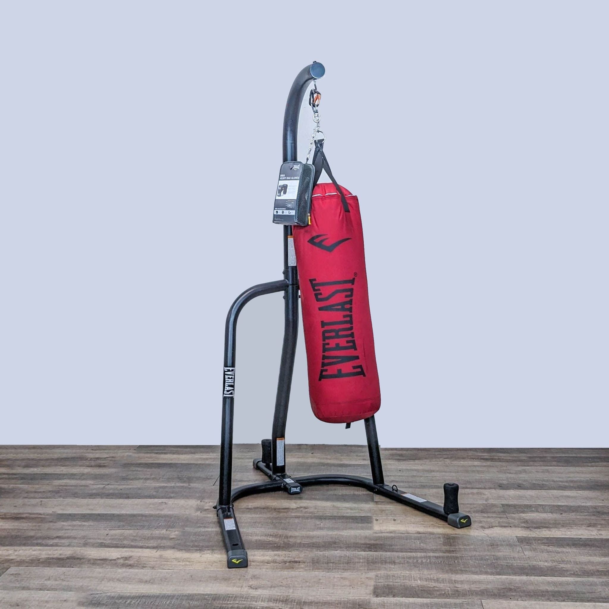 Everlast gym gear featuring a sturdy red punching bag on a free-standing black frame, suitable for improving strength and agility.