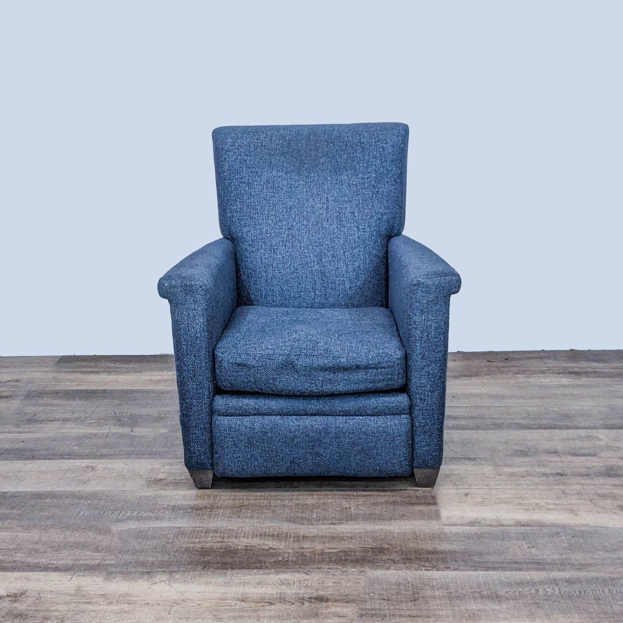 Comfortable Crate & Barrel Declan manual recliner in upright position with sturdy frame and blue upholstery.