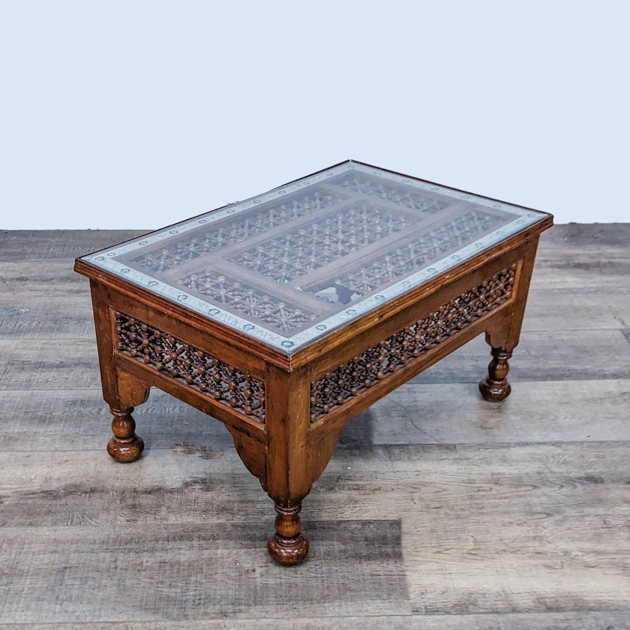 3. Angled perspective of a traditional Reperch coffee table with mashrabiya panels and mother-of-pearl inlay, showcasing missing section.