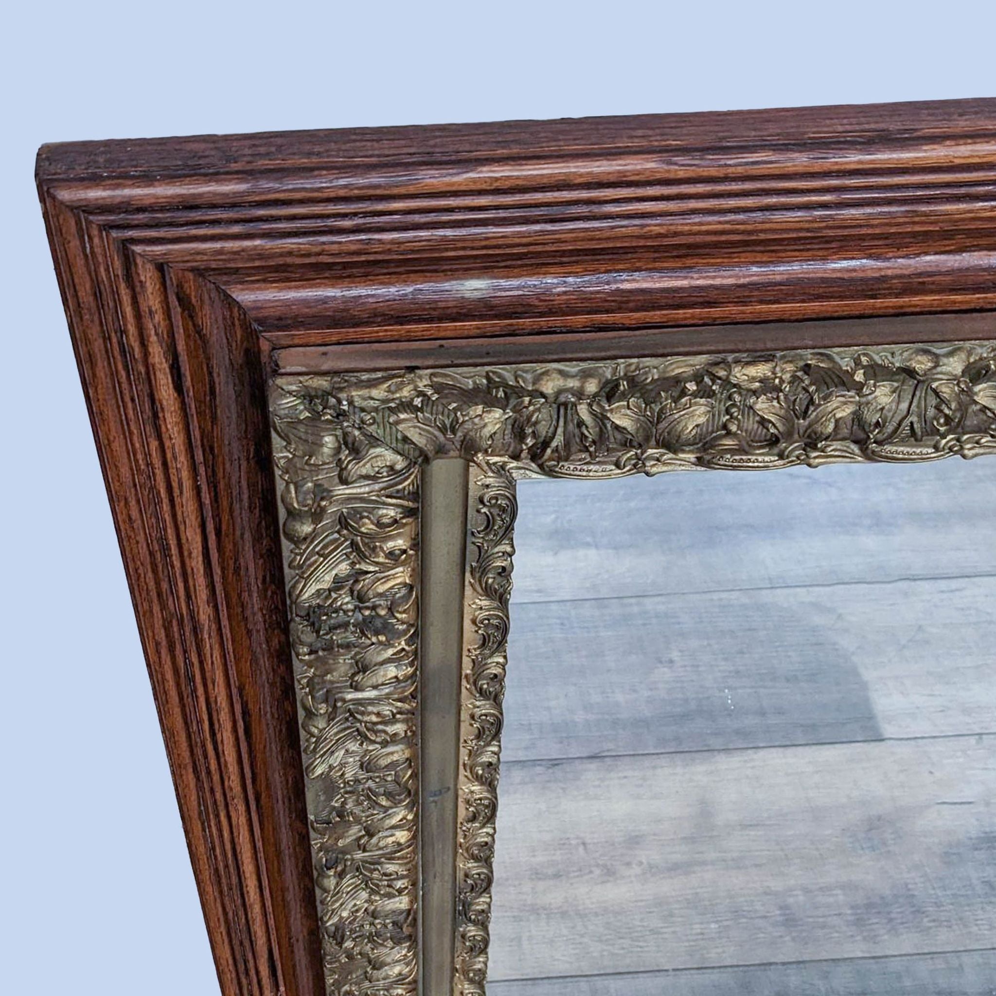 Classic square Reperch mirror featuring a richly ornamented wooden border and reflective glass on a wood-textured surface.