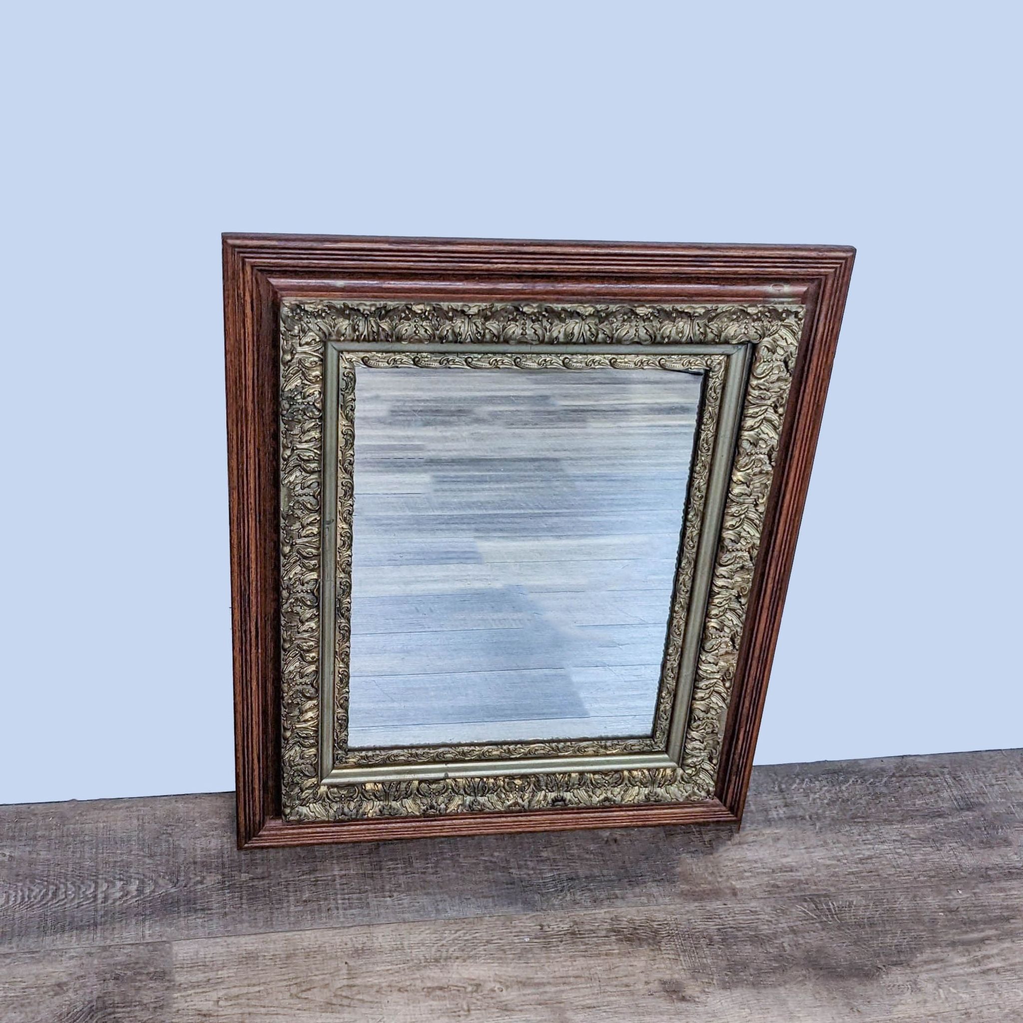 Reperch brand wall mirror with ornate wooden frame on a wooden floor against a plain background.