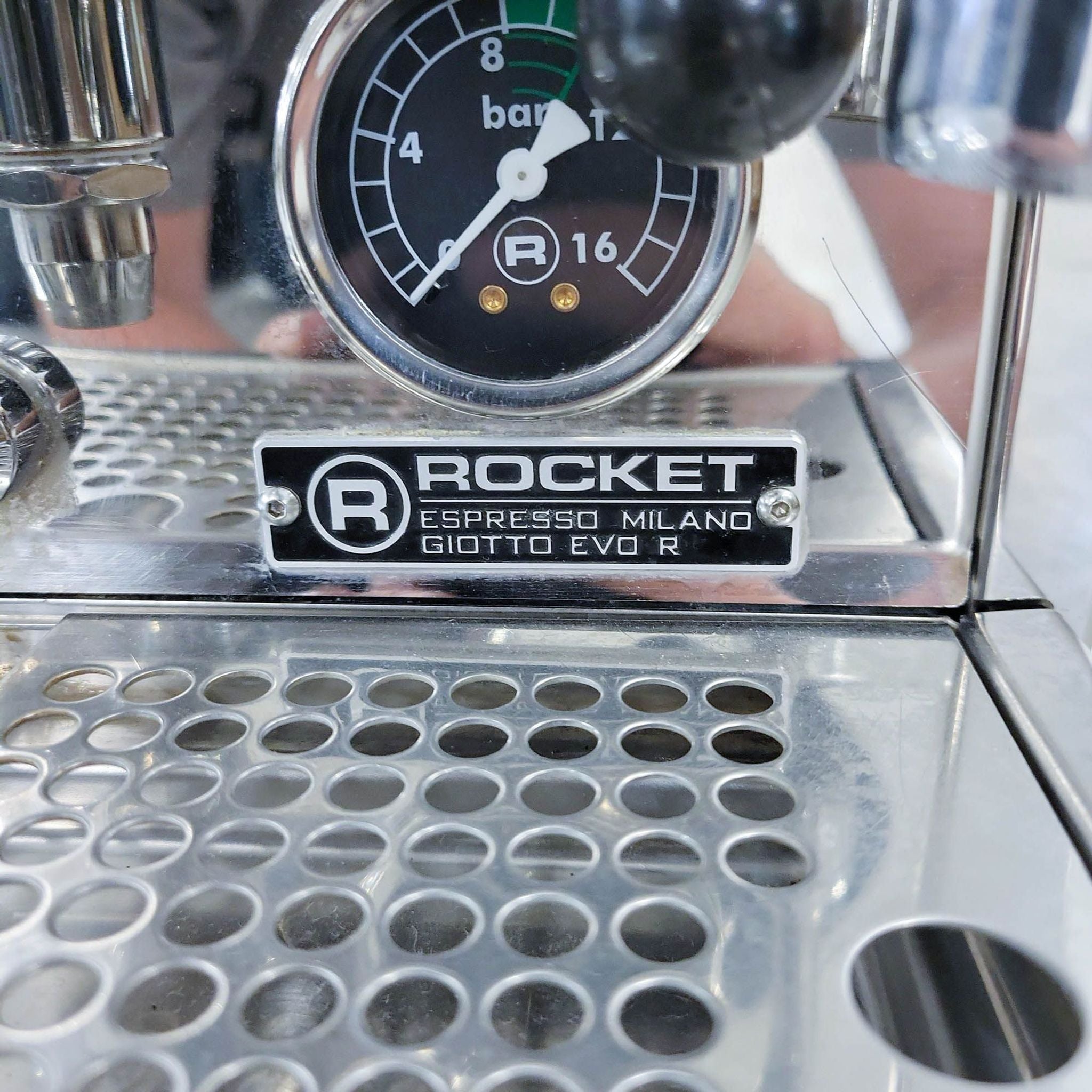 Close-up of a Rocket Espresso Milano Giotto Evo R machine with pressure gauge and shiny metal finish.
