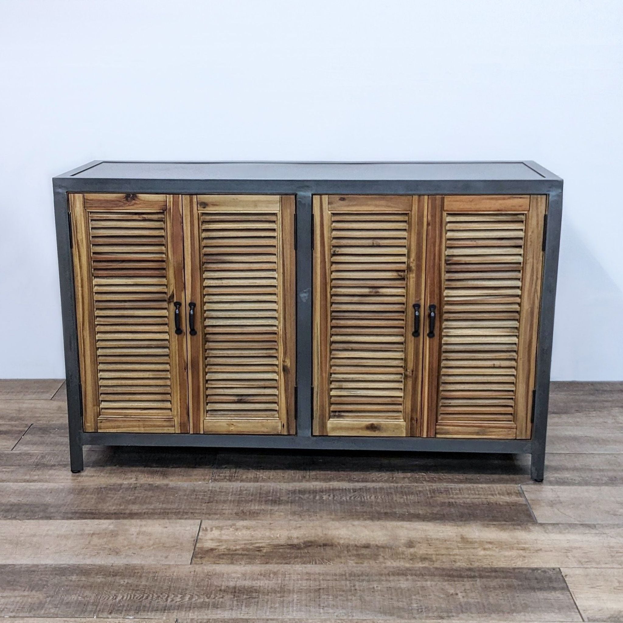 Industrial-style World Market sideboard with closed louvered cabinet doors on metal frame.