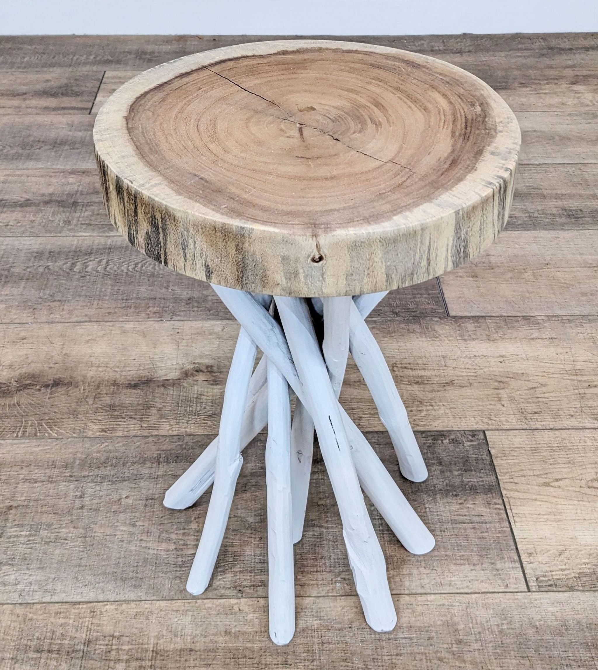 Reperch branded side table with a natural wood top and white multi-branch base on a wooden floor.