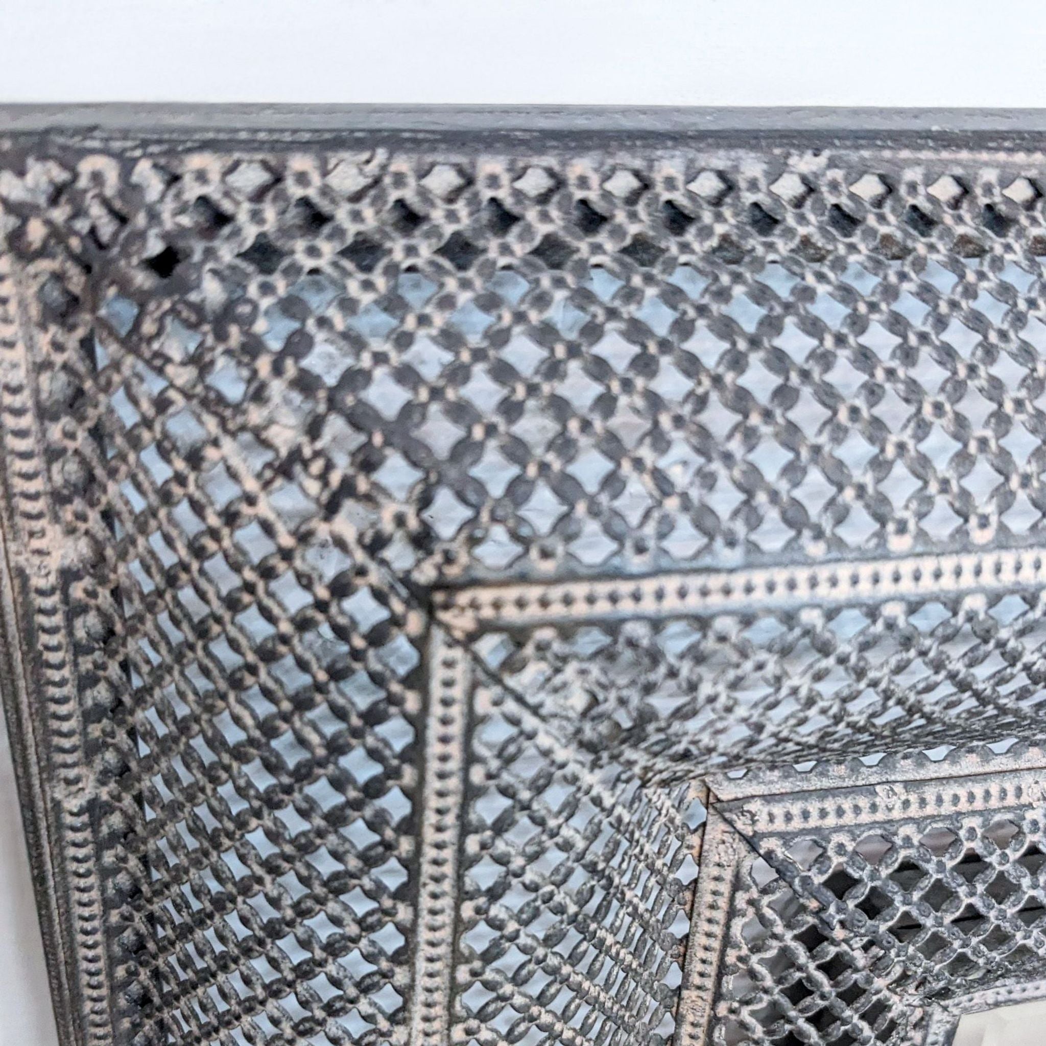 Close-up of Uttermost mirror showing detailed texture on the stylish frame.