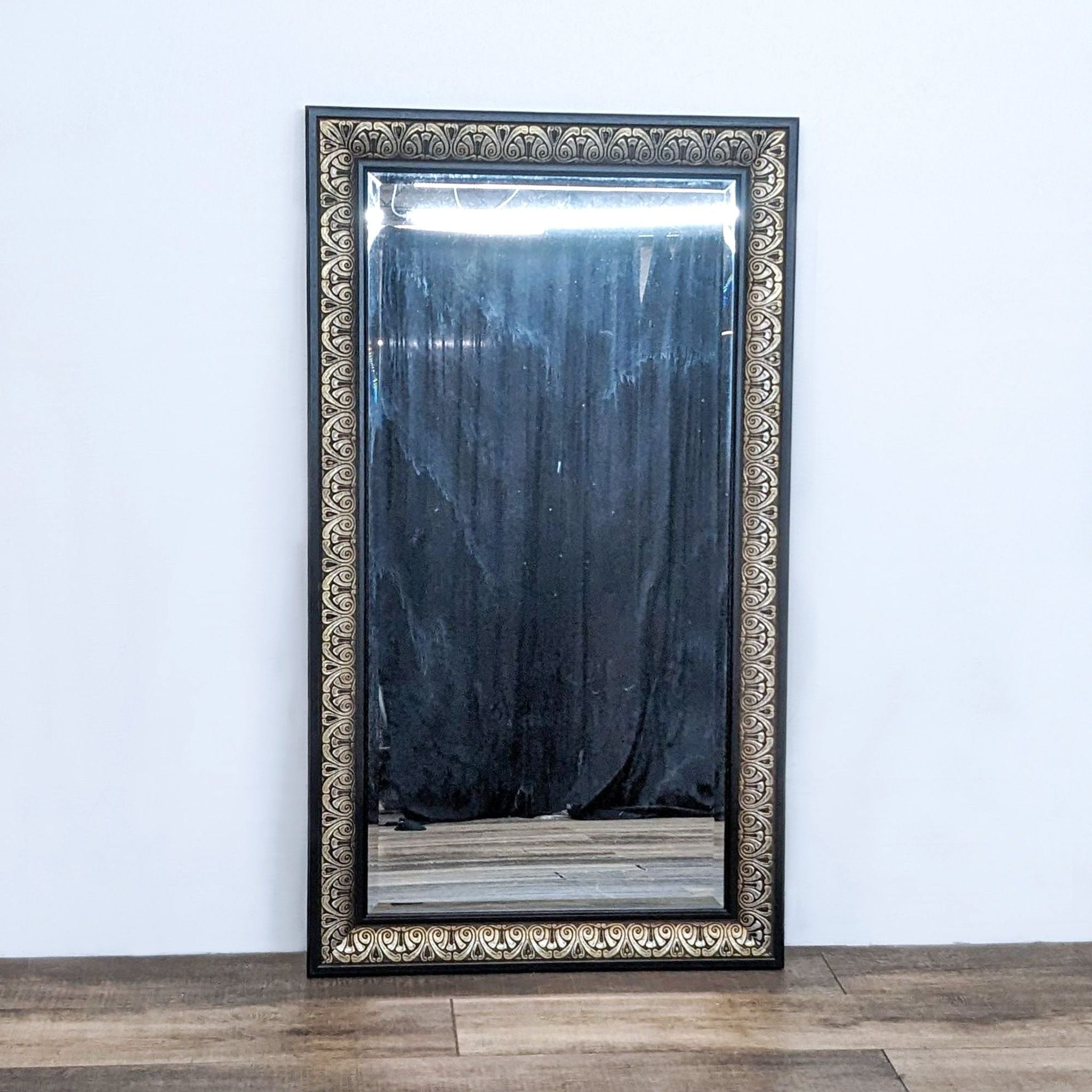 1. World Market antique brass-finished rectangle mirror with carved detailing on a dark frame, displayed against a white wall and wooden floor.