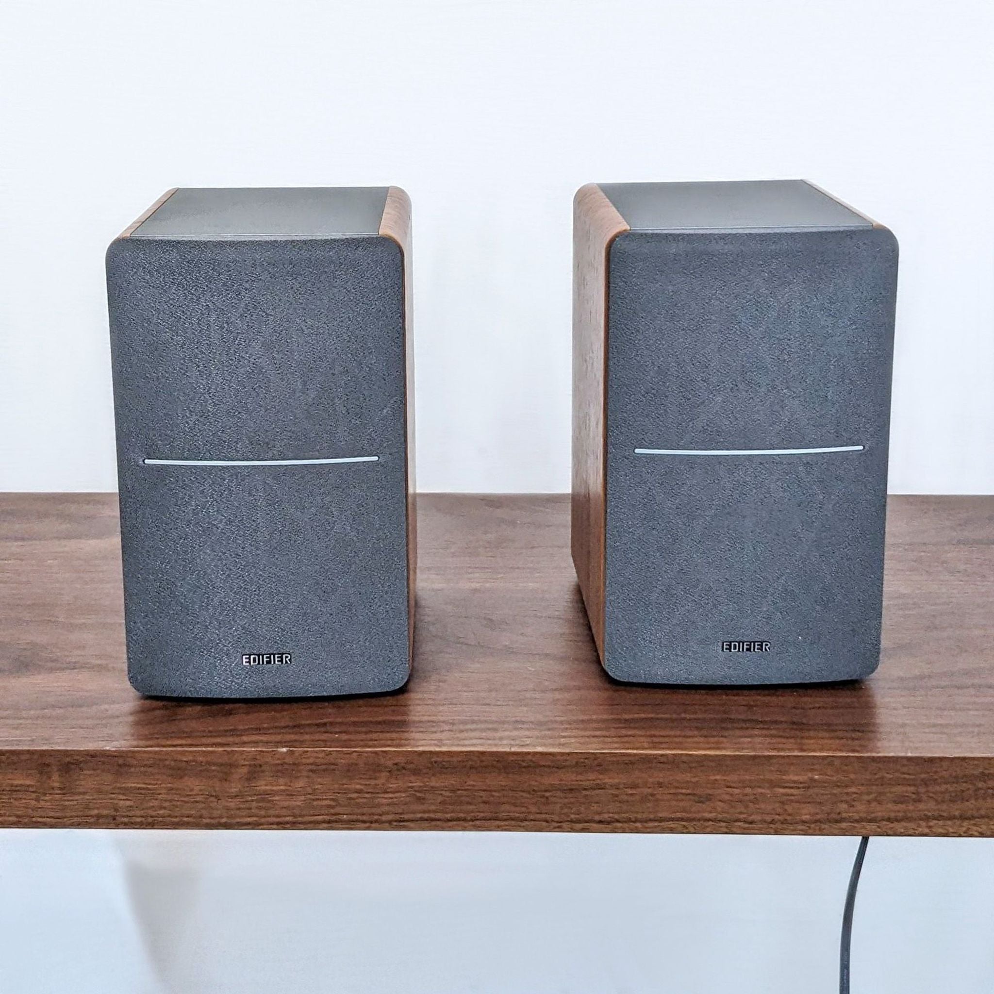 Edifier bookshelf speakers with wood-finish accents and Bluetooth connectivity for audio streaming.
