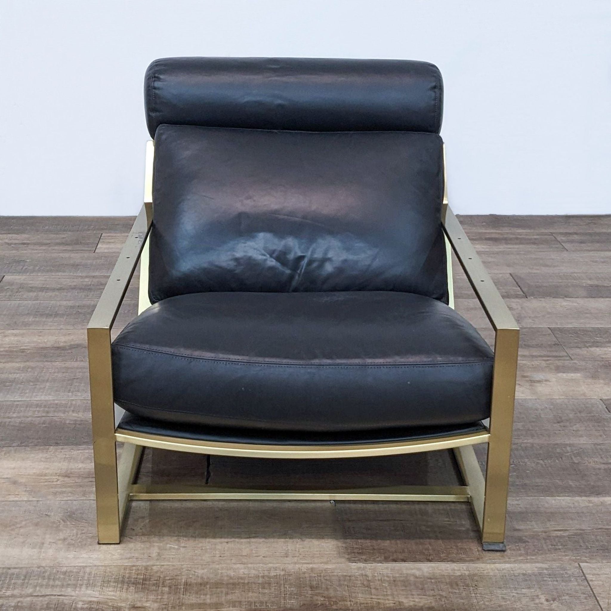 Alt text 1: Milo Baughman's Cruisin' lounge chair by Thayer Coggin with a brushed bronze frame and black leather upholstery, front view.