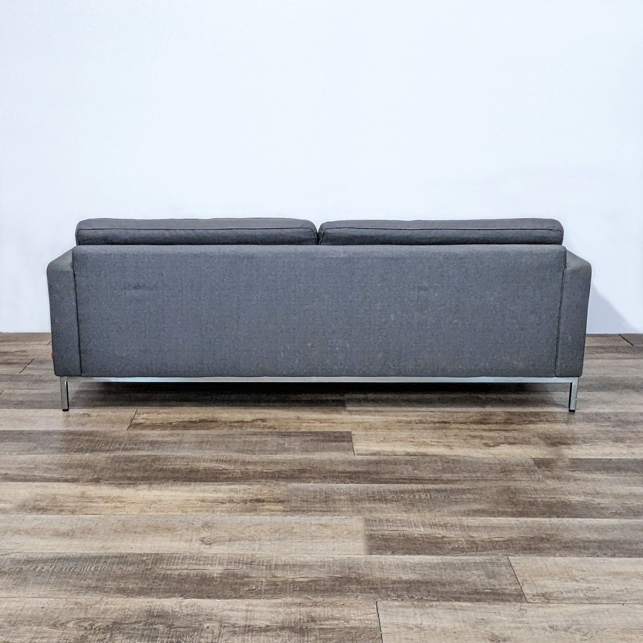 EQ3 charcoal 3-seat sofa showcasing tufted upholstery, slim arms, and chrome legs, viewed from various angles.