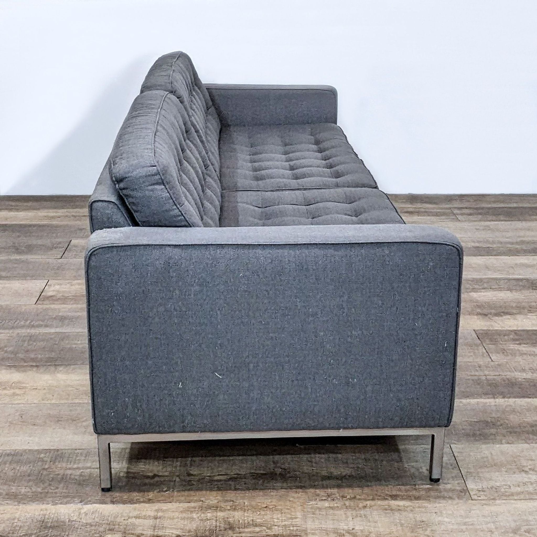 Charcoal fabric EQ3 3-seat sofa with button tufting and narrow arms on a chrome frame, made in Canada.