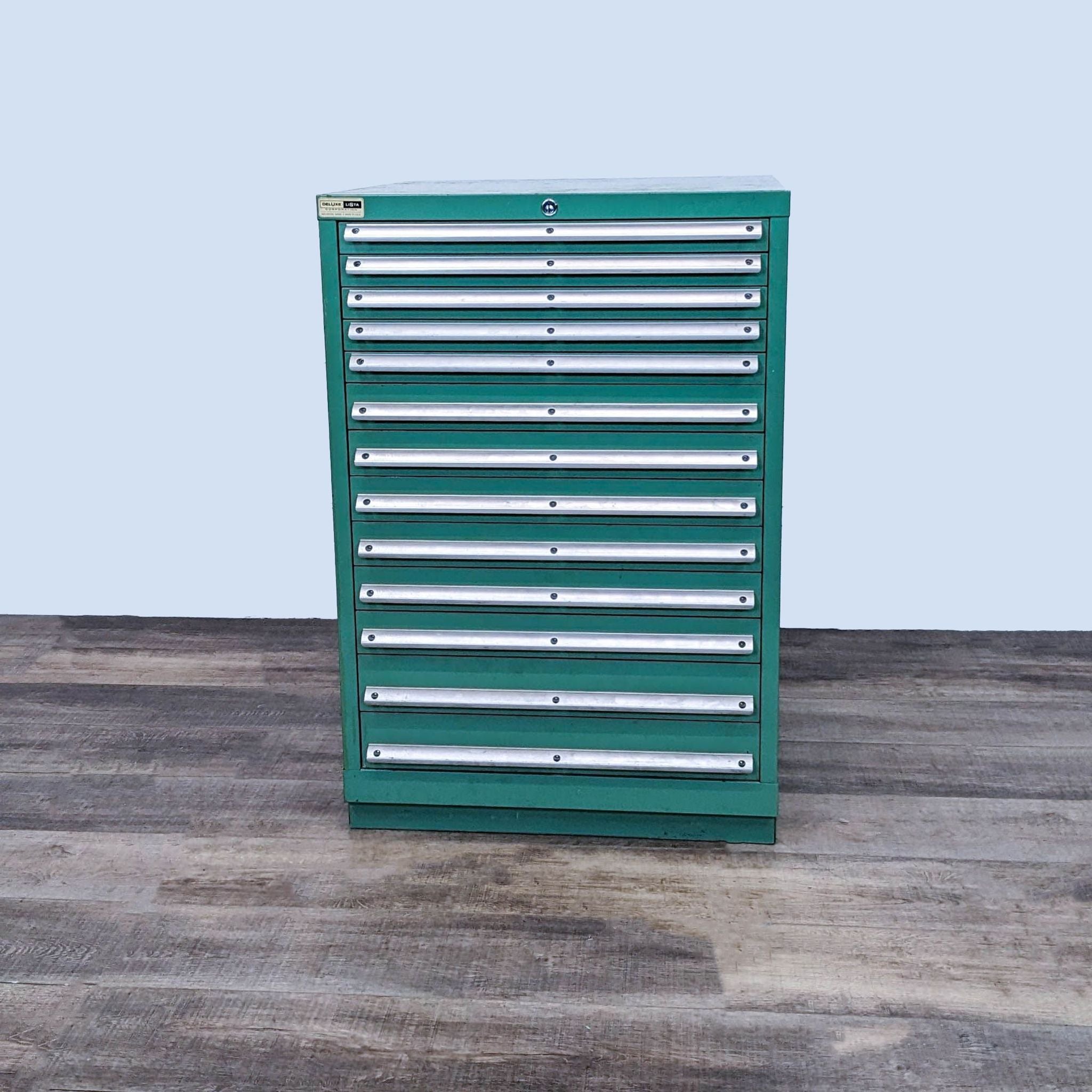 Lista 13-drawer metal tool cabinet in green, front view, closed drawers on a wooden floor.