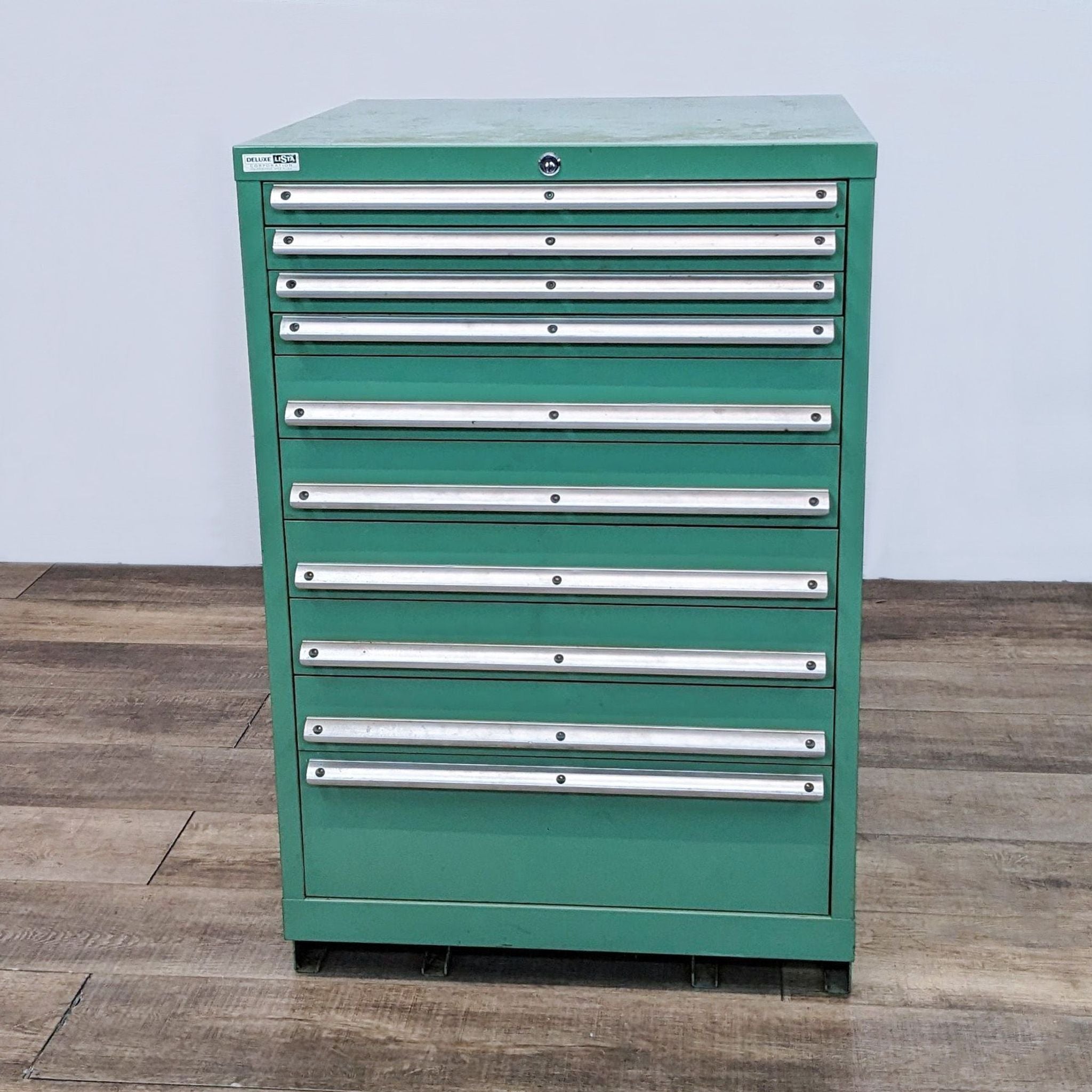 Alt text 1: Green Lista tool storage cabinet, closed drawers, sturdy metal design, multiple sized drawers, ideal for tool organization.