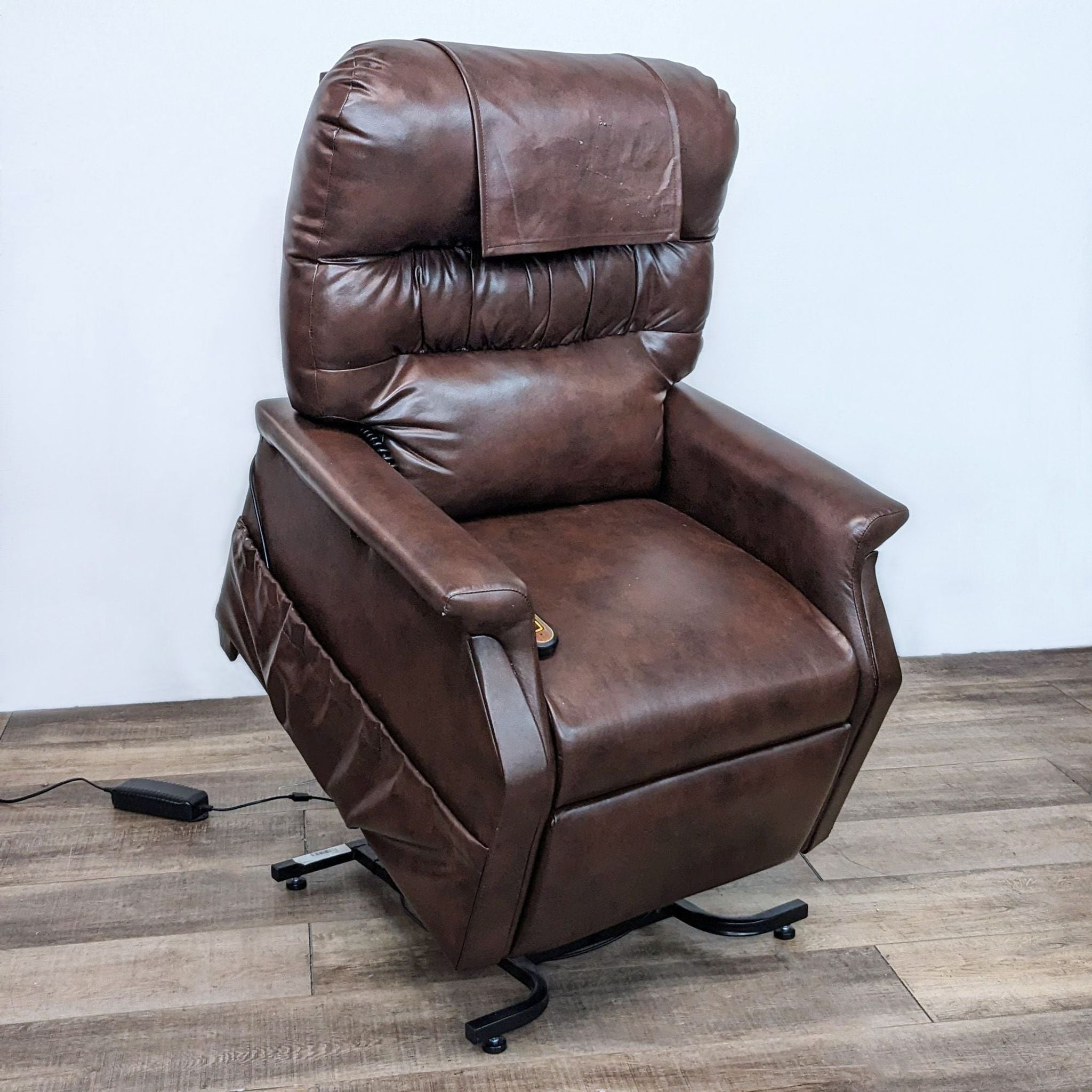 Brown PowerLift recliner by Golden Technologies with extended leg rest and side pockets, shown at an angle on wood flooring.