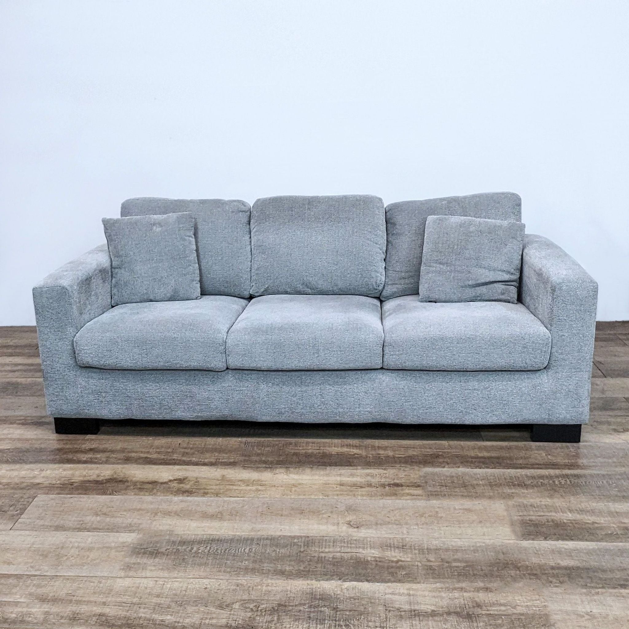 Reperch brand 3-seat compact gray fabric sofa with plush cushions and square arms on a wooden floor.