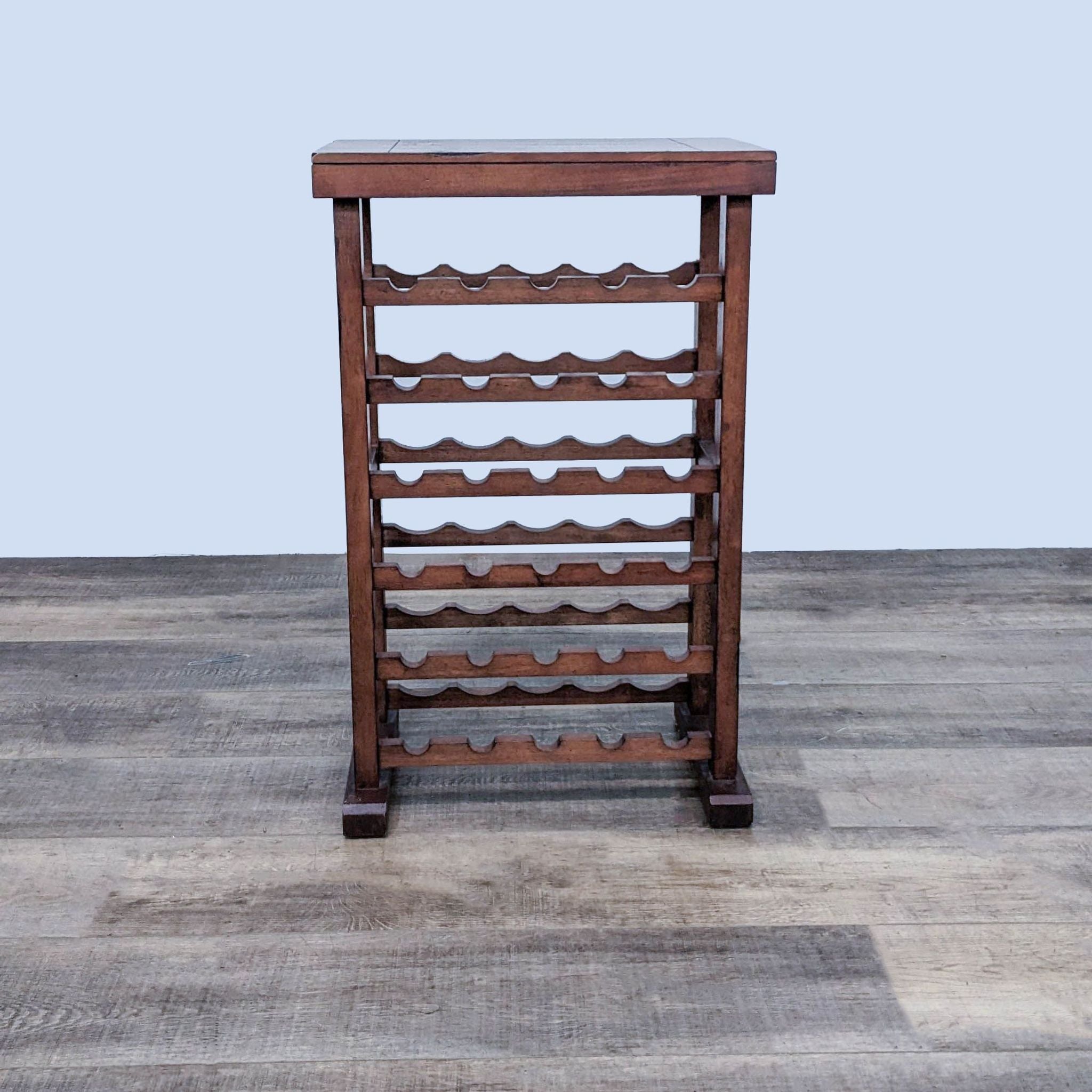 Wooden wine rack by Reperch with multiple scalloped shelves, on gray floor.