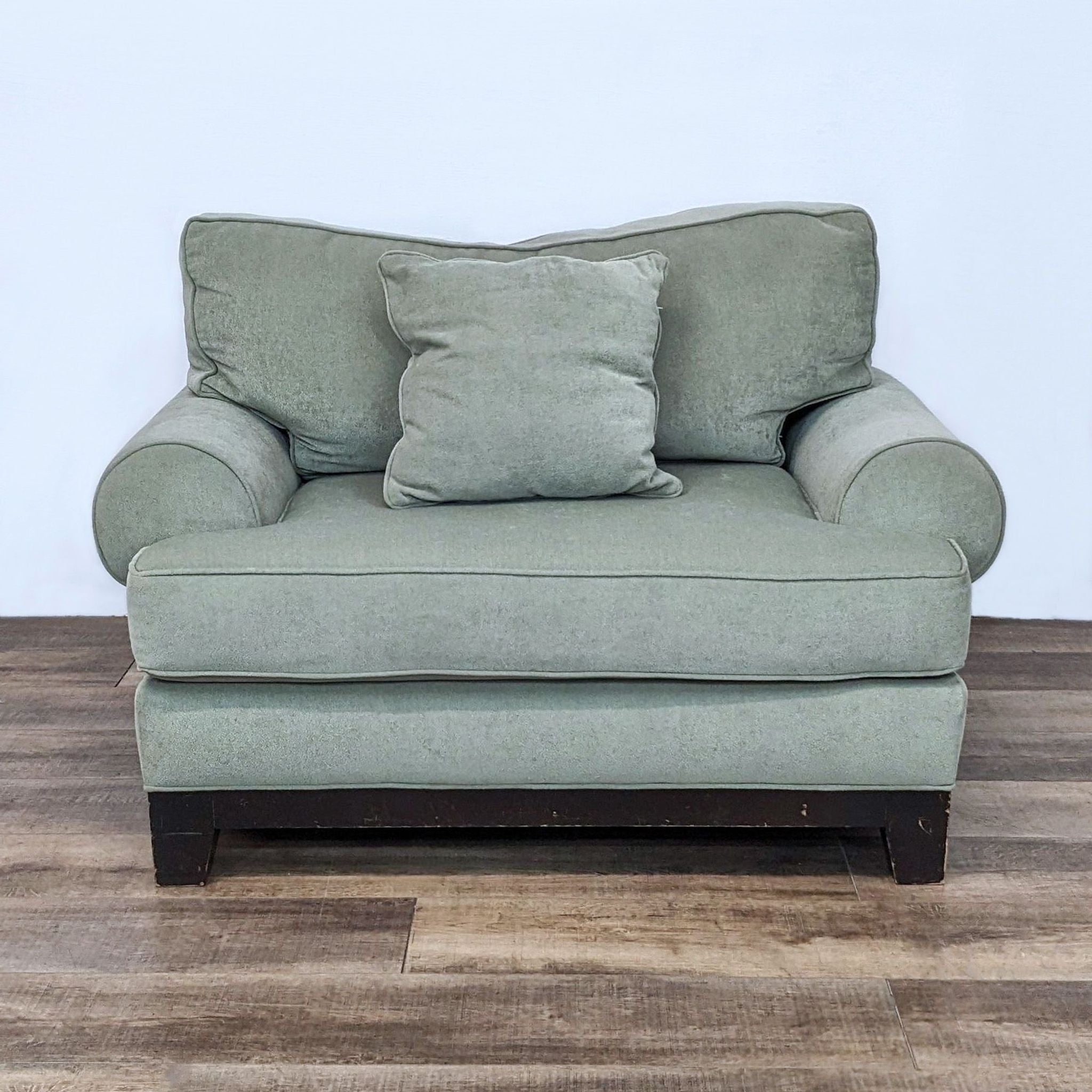 Alt text 2: Comfortable reading chair by Reperch with soft green upholstery and plush cushions, includes material tag detail.