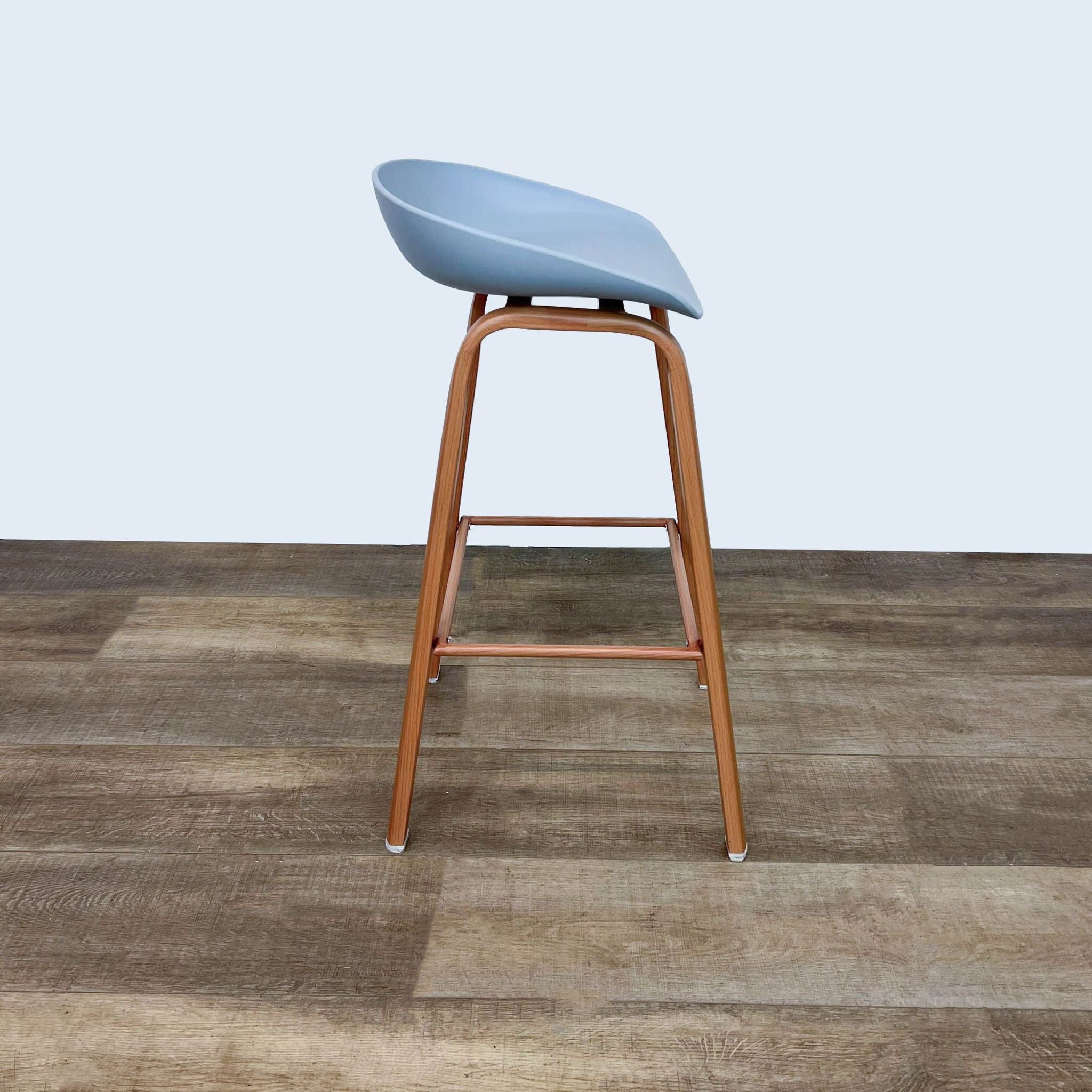 Sleek Reperch gray plastic seat barstool with solid wood legs, angled perspective.