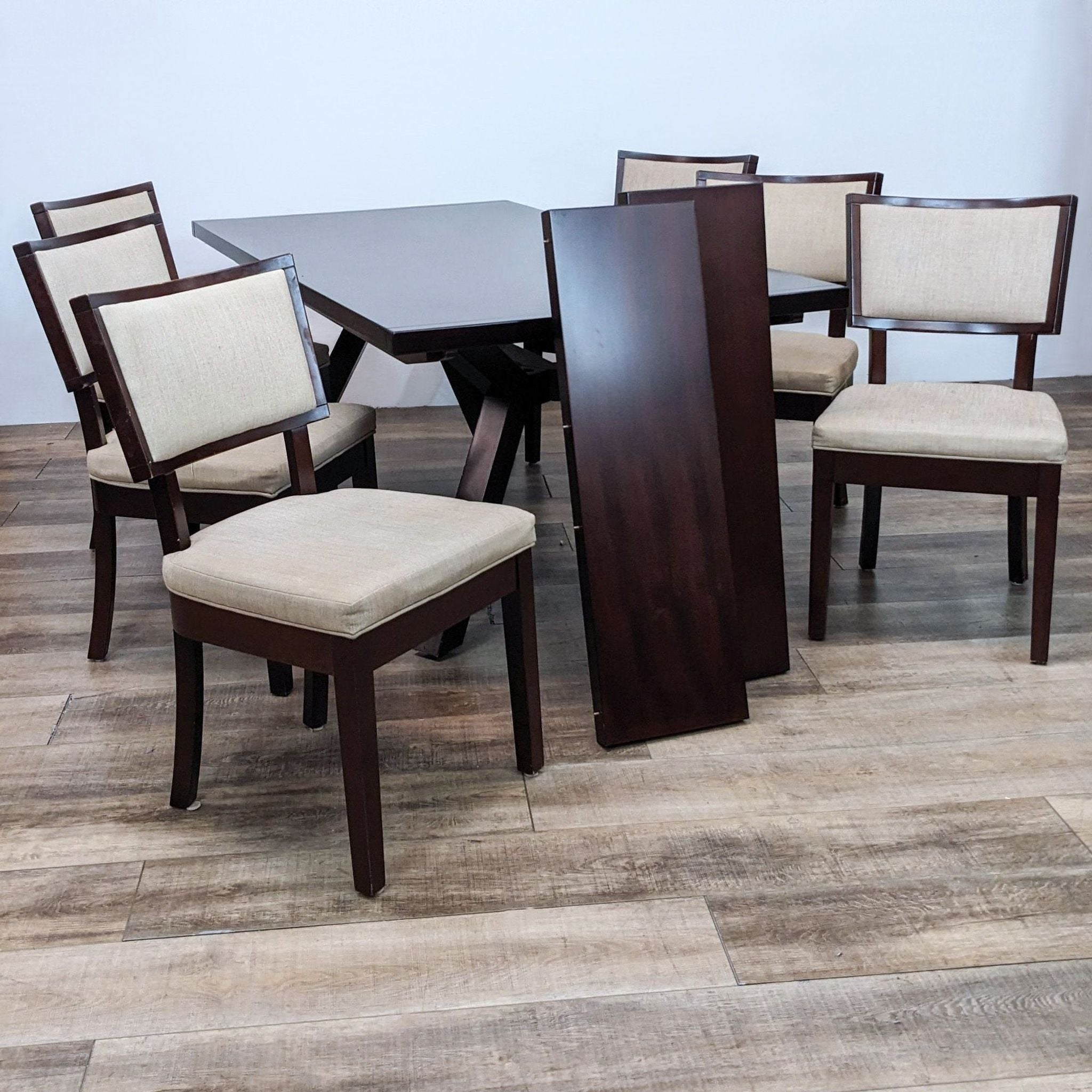 Alt text 1: Modern 7-piece Sitcom dining set with a dark wood table and six chairs with neutral fabric upholstery on a wooden floor.