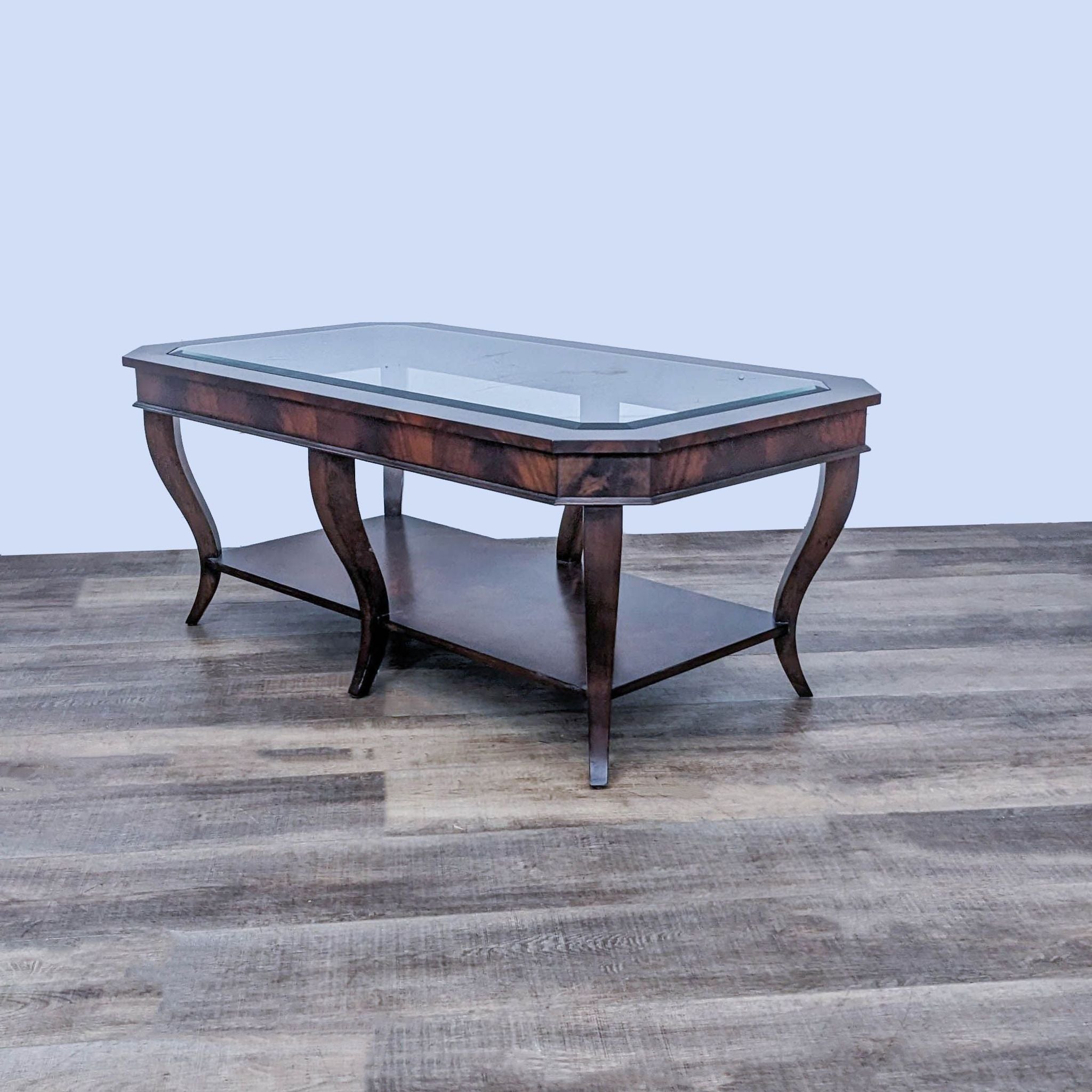 Rectangular Ethan Allen coffee table featuring mahogany finish, glass insert top, and elegant cabriole legs.