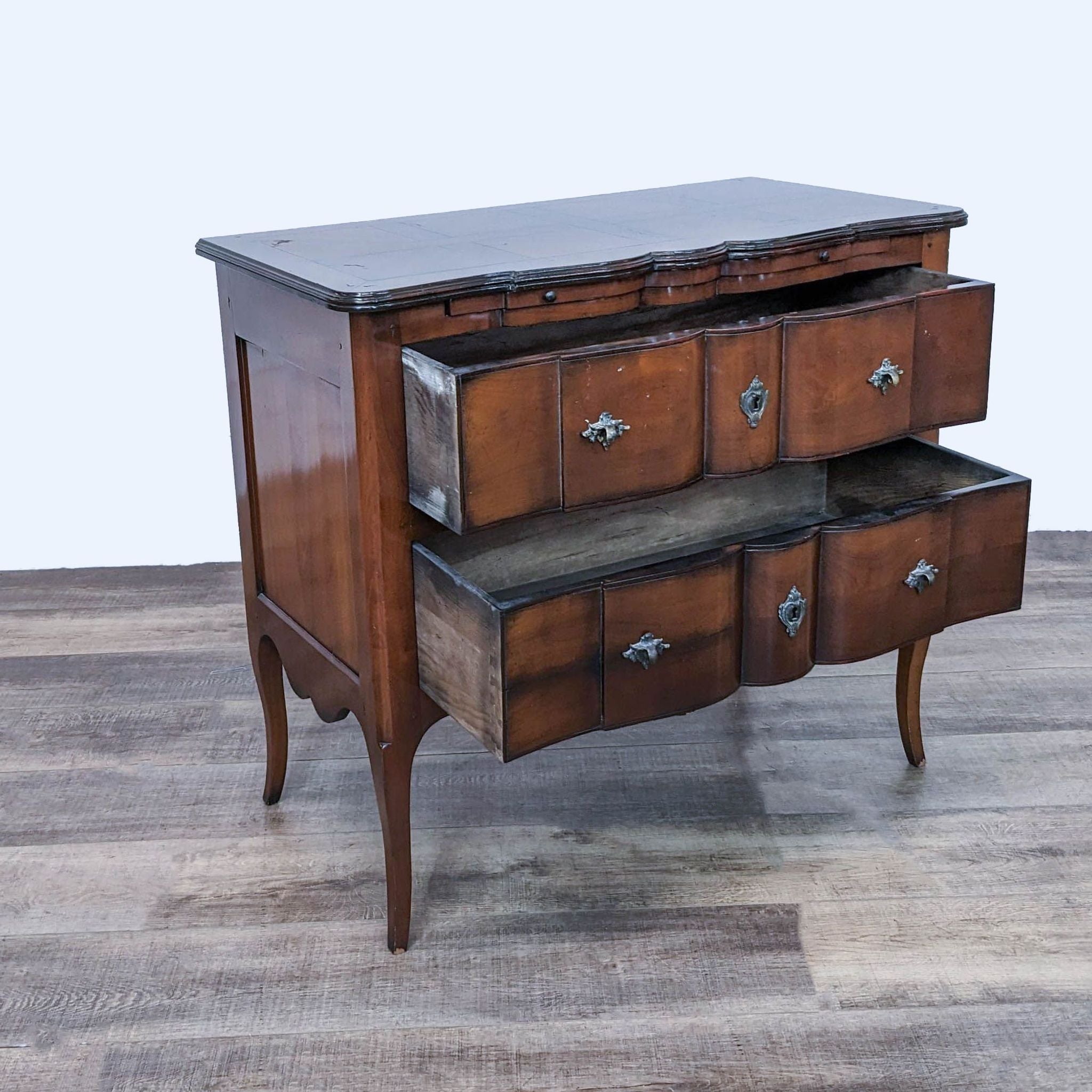 DeBournay dresser with open drawers showcasing dovetail joinery and curved front, set on elegant curved legs.