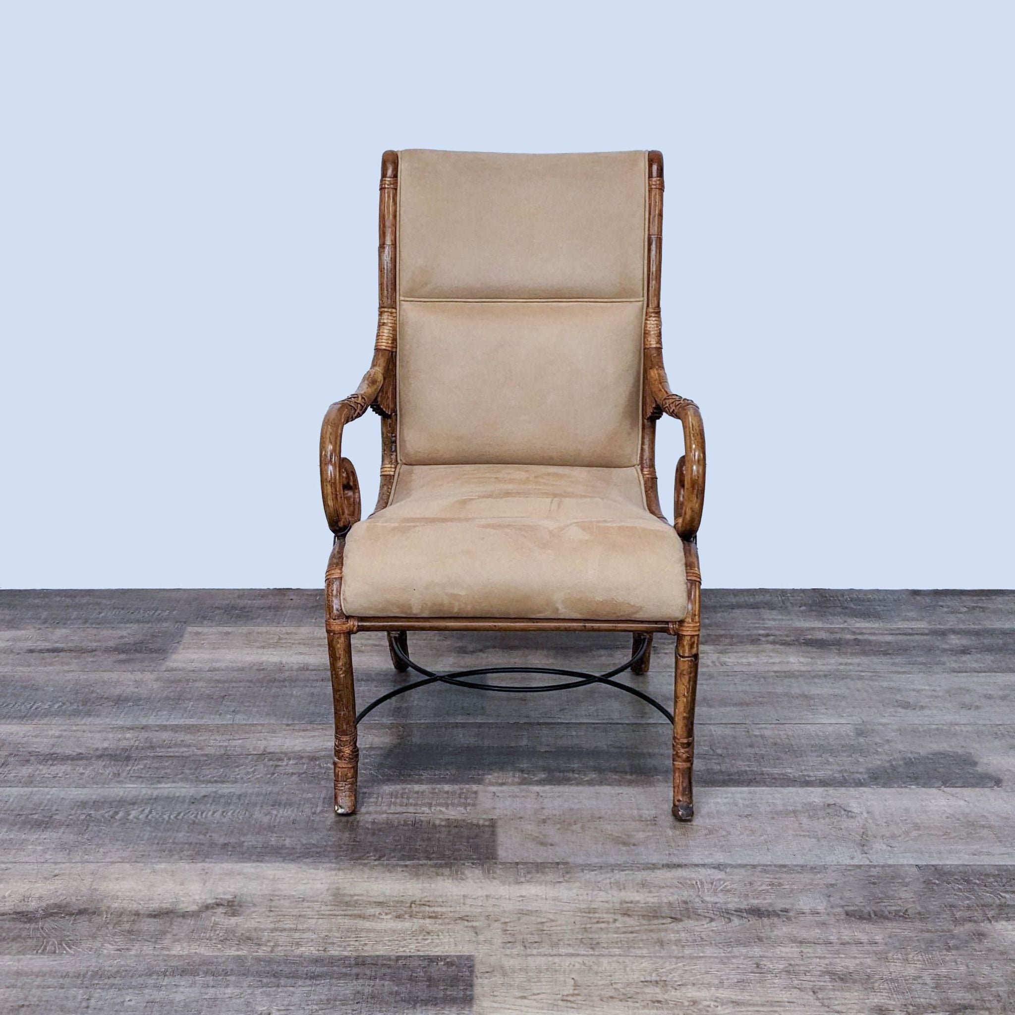 Reperch contemporary bamboo-framed armchair with rattan details and cushioned leather seat on wooden floor.