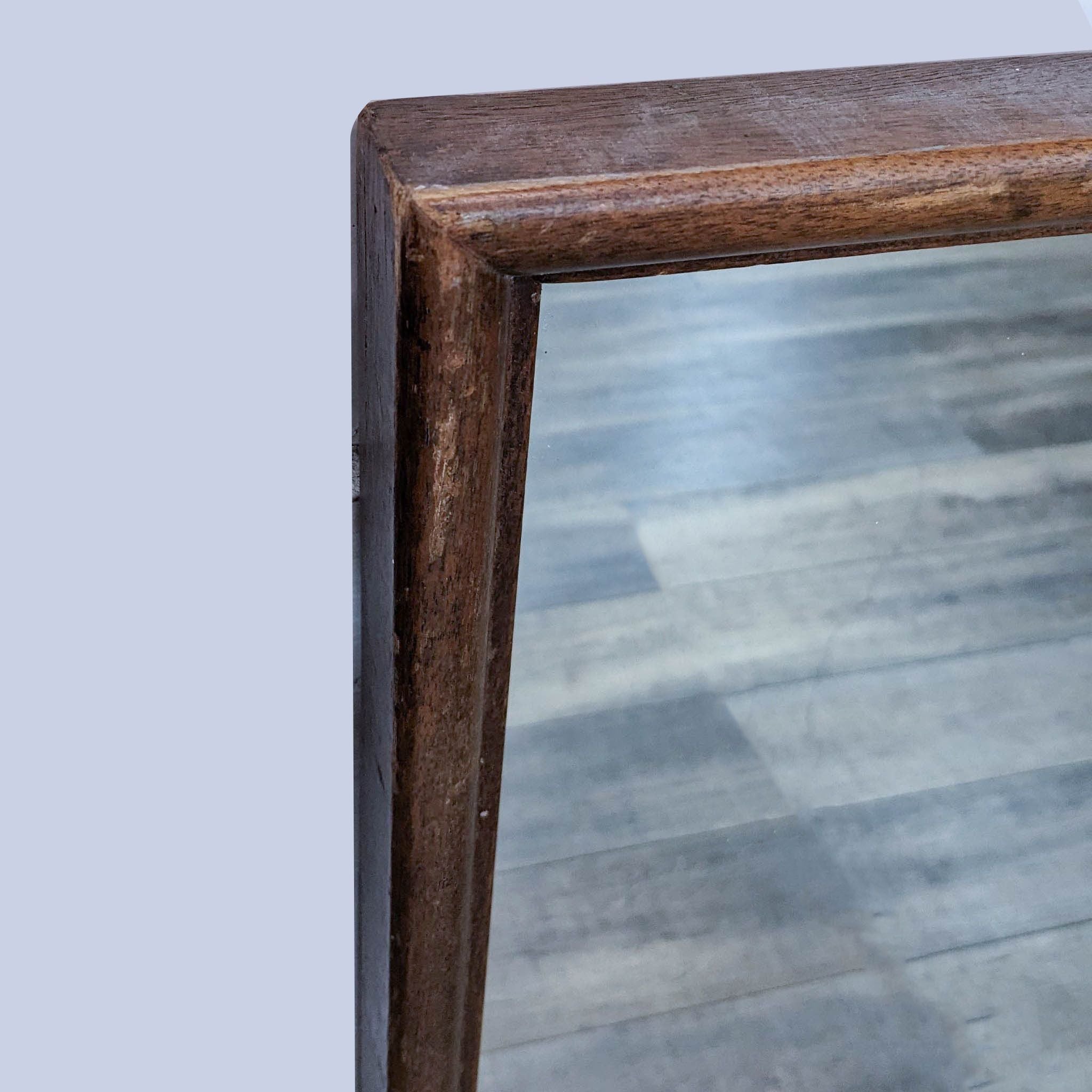 Close-up of a vintage Reperch oak-framed mirror, highlighting the wood texture.