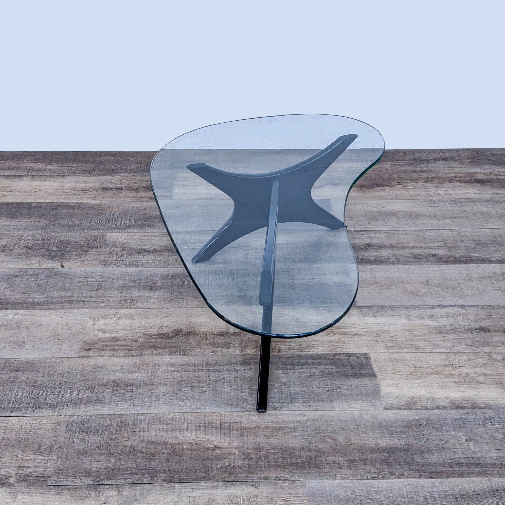 Adrian Pearsall-inspired Reperch coffee table featuring a glass top on a tripod wooden base, viewed from above.