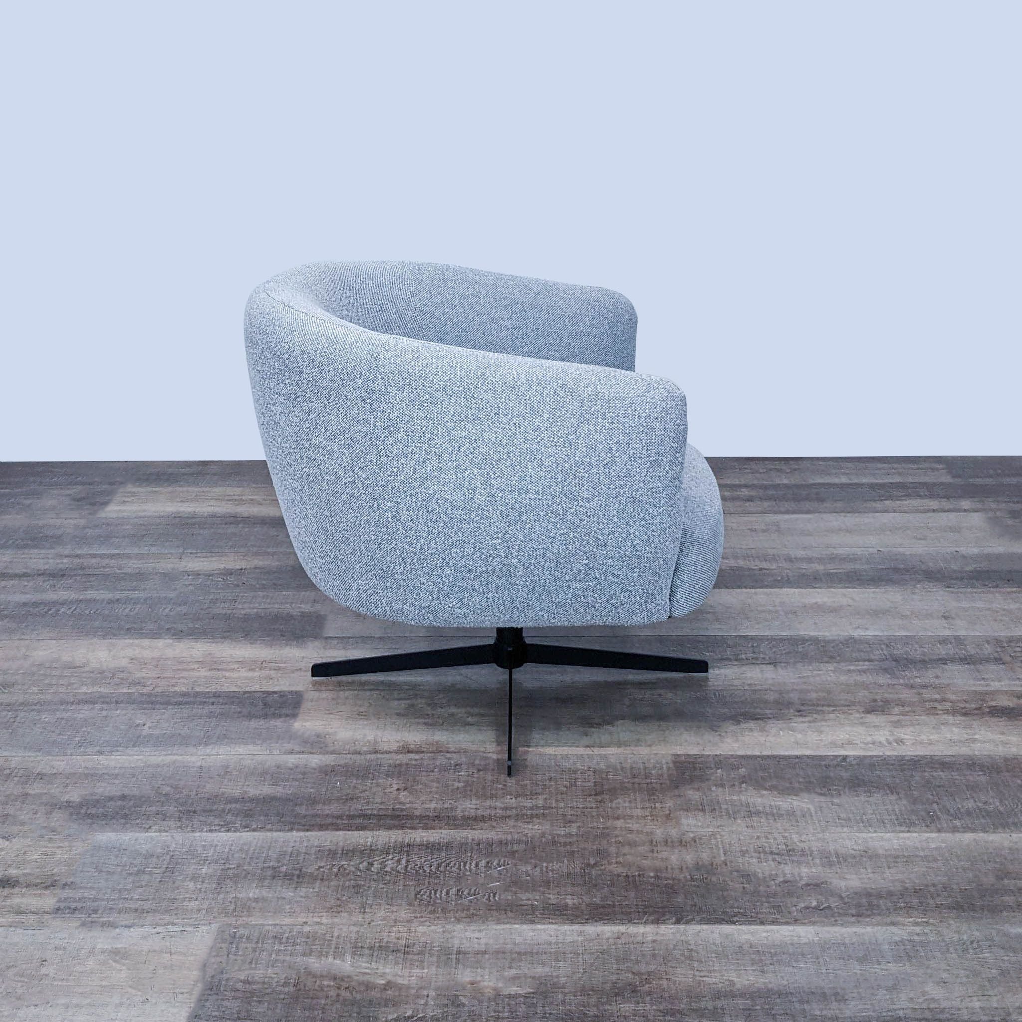 360-degree rotating lounge chair by Target featuring robust metal base and light grey chenille upholstery.