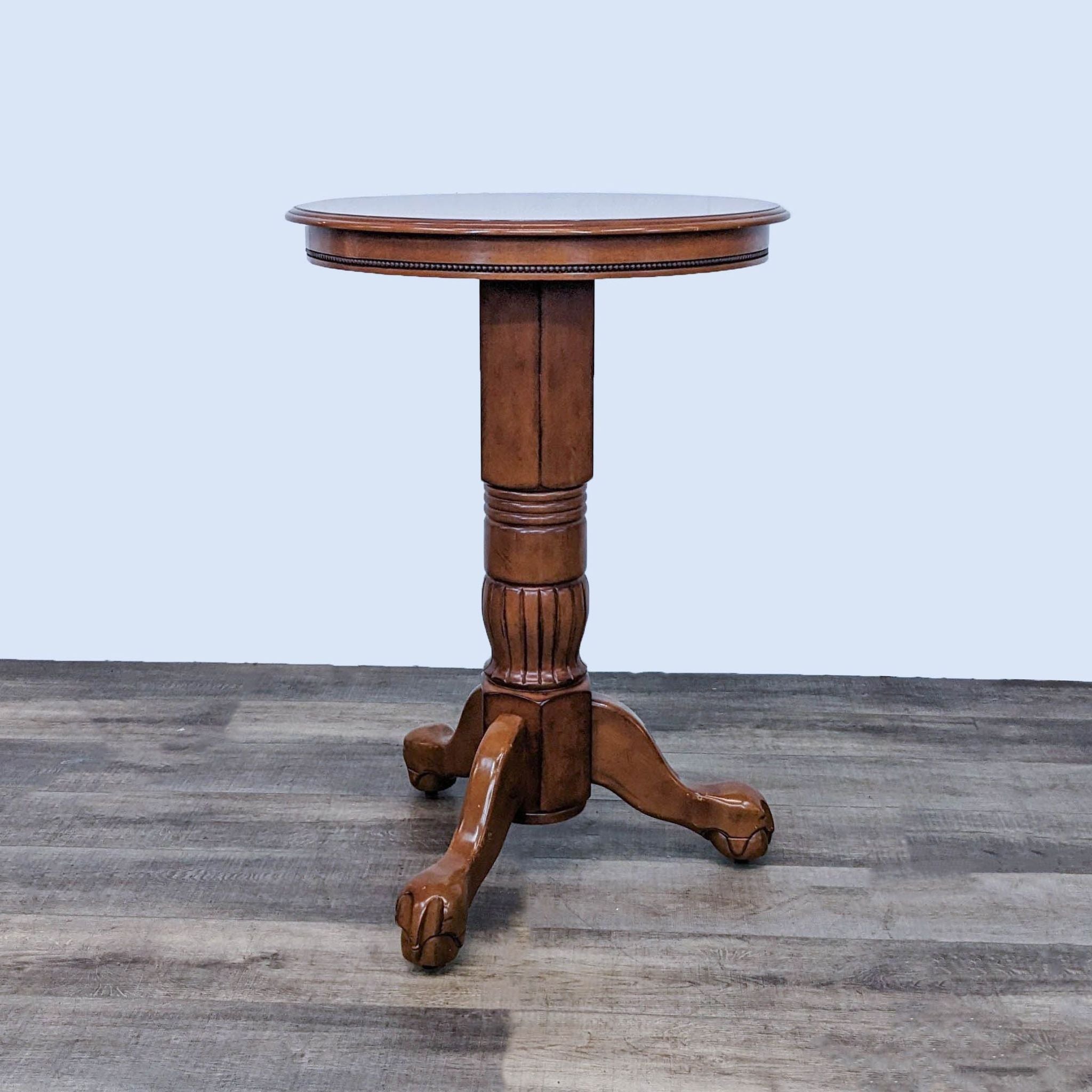 Round wood pin table with single pedestal base from Pier 1 Imports, part of a 3 piece counter height dining set.