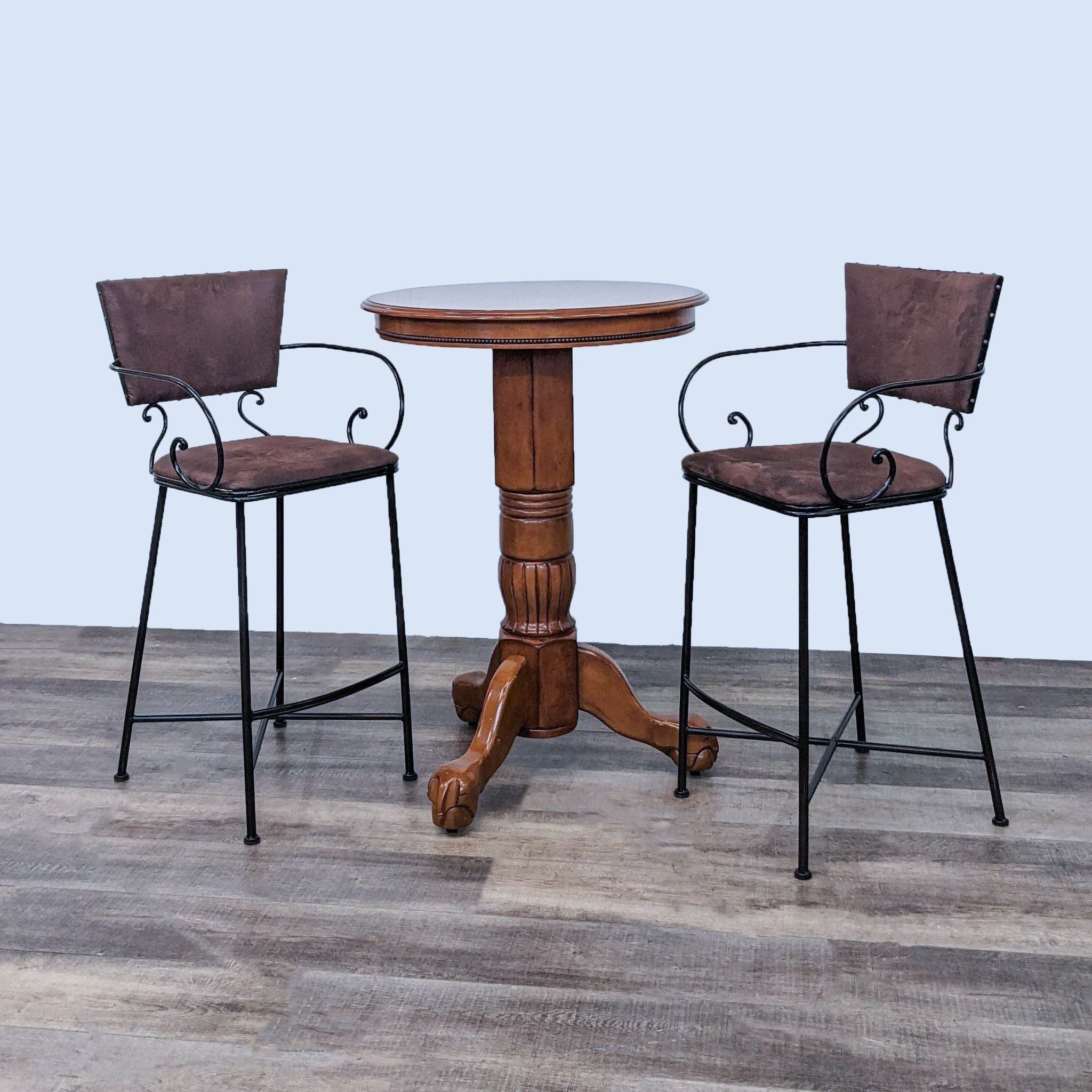 Pier 1 Imports dining set with two metal upholstered Chesington stools and a round wooden pedestal table.