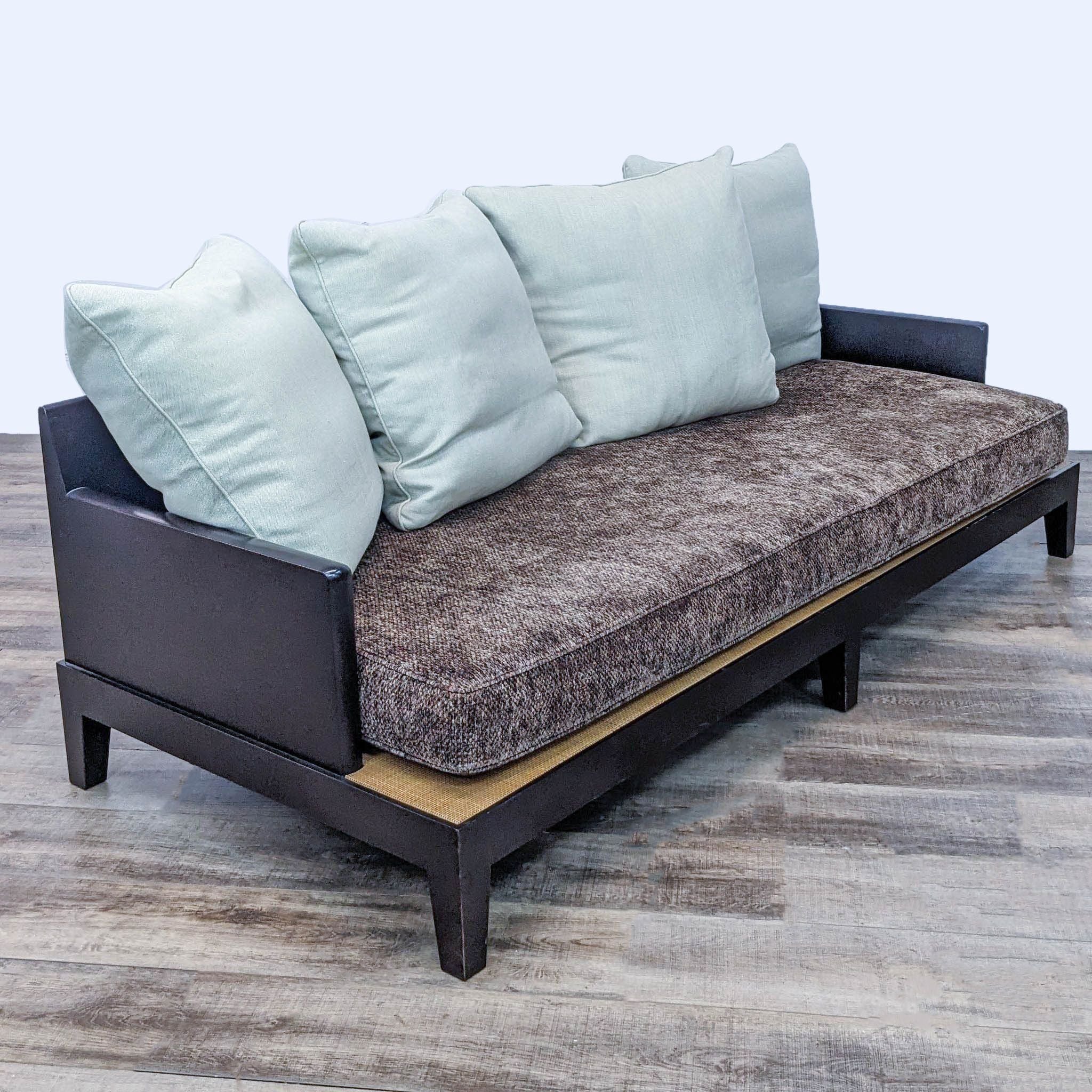 Modern sofa by Reperch with narrow arms, removable brown and blue cushions shown from various angles.