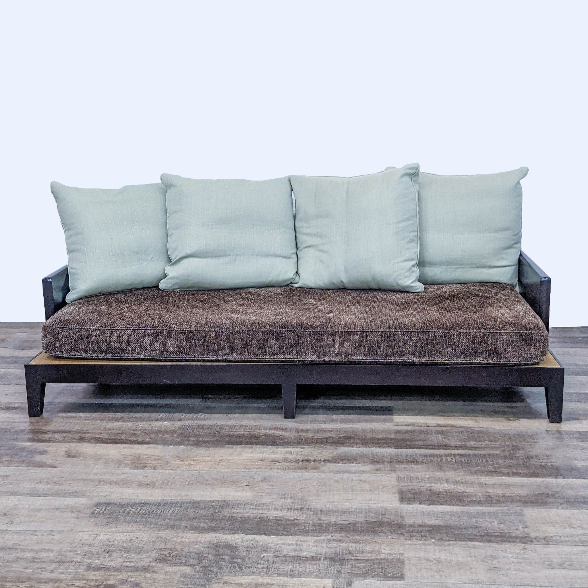 Reperch brand sleek wood frame sofa with brown textured fabric and pastel blue back cushions, on wood floor.