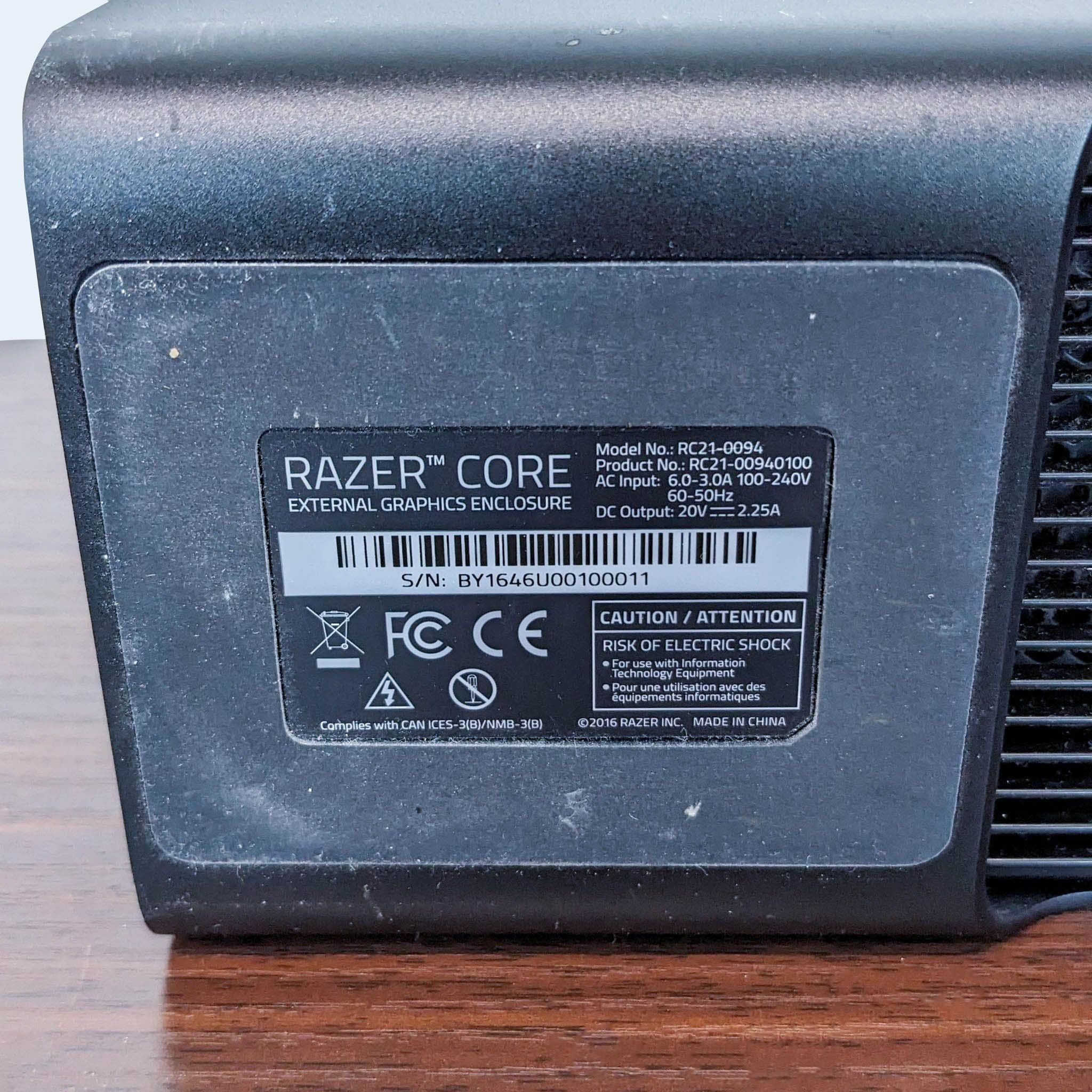 Razer Core external graphics enclosure label close-up, showing product details and warnings on a textured black surface.