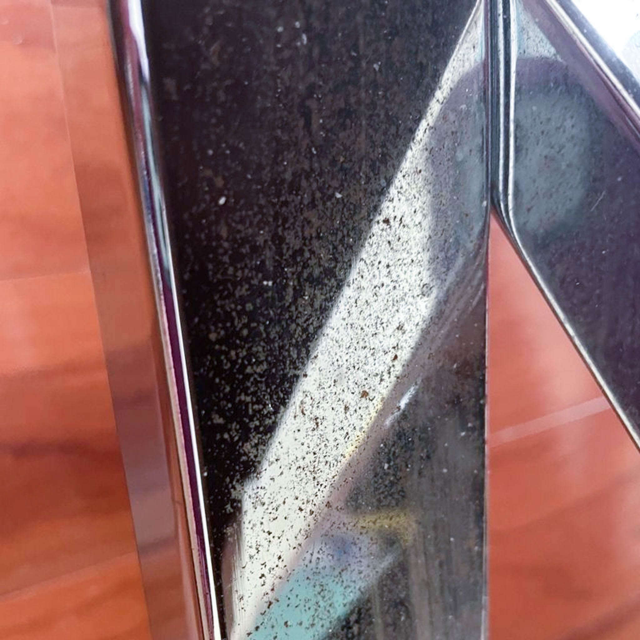 Alt text 2: Close-up of tarnished metal coffee table frame detail, showing signs of wear and tarnish, from Cost Plus brand.