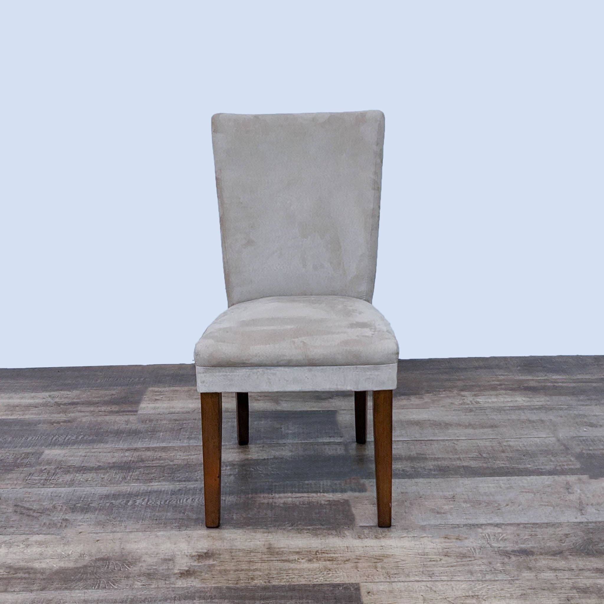 Reperch Parsons dining chair with light gray faux suede and wooden legs, front view on wooden floor.