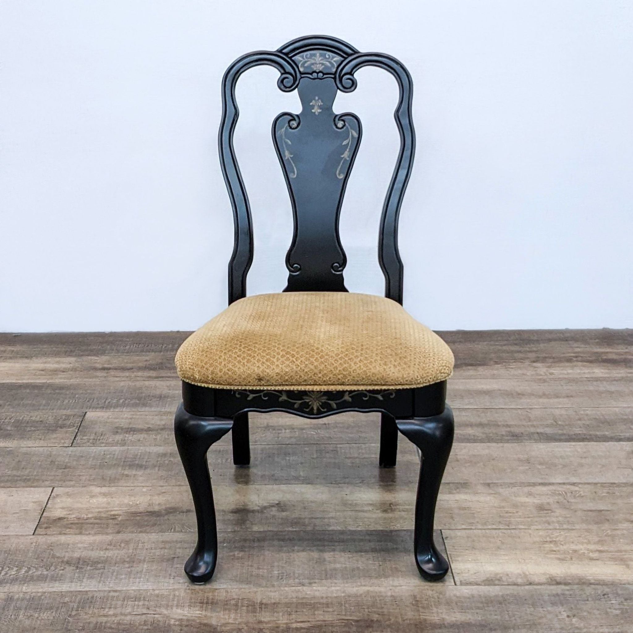 Queen Anne style black dining chair by A.R.T. Furniture Co. with floral details and upholstered seat.