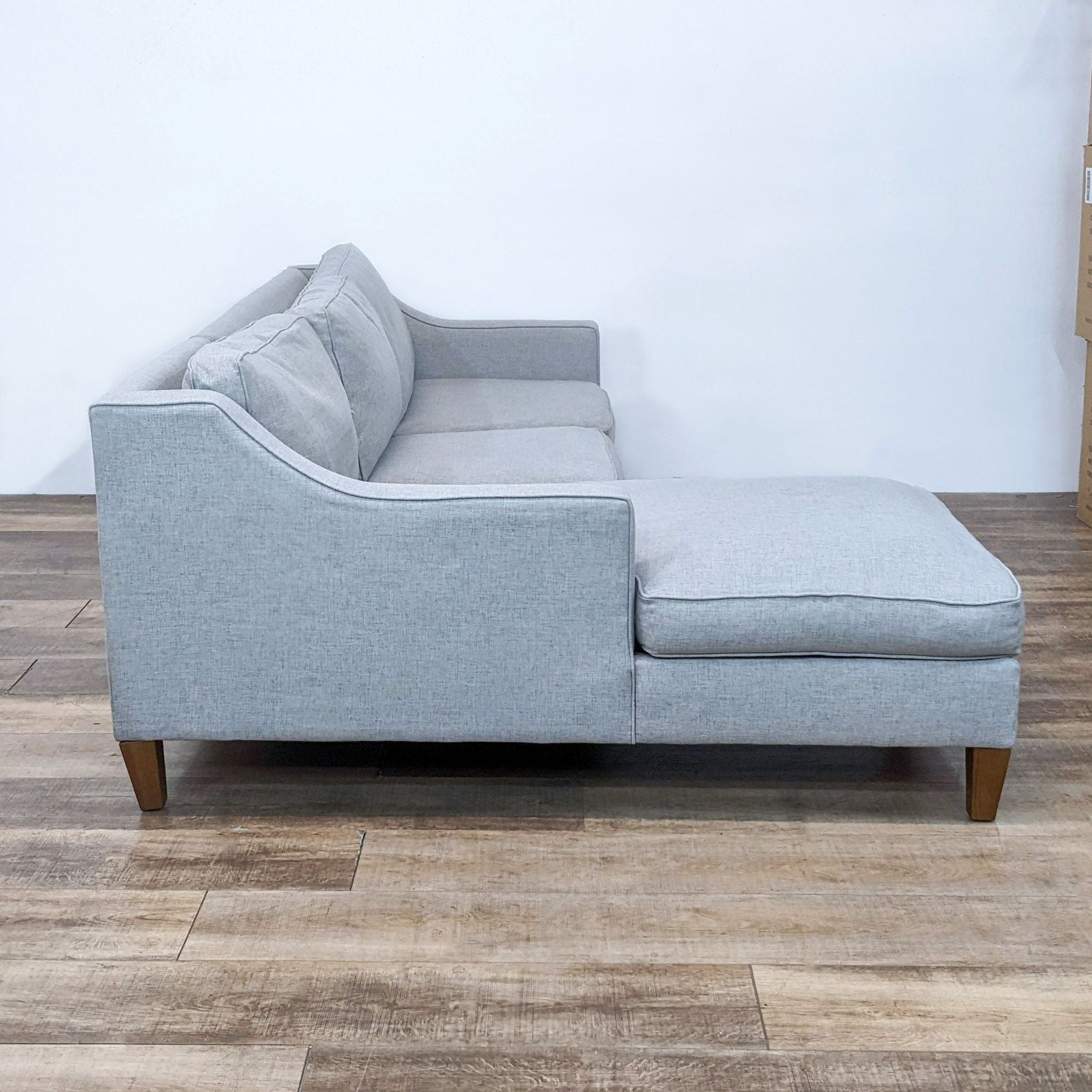 West Elm sectional sofa with chaise in gray fabric, featuring wood finish feet.