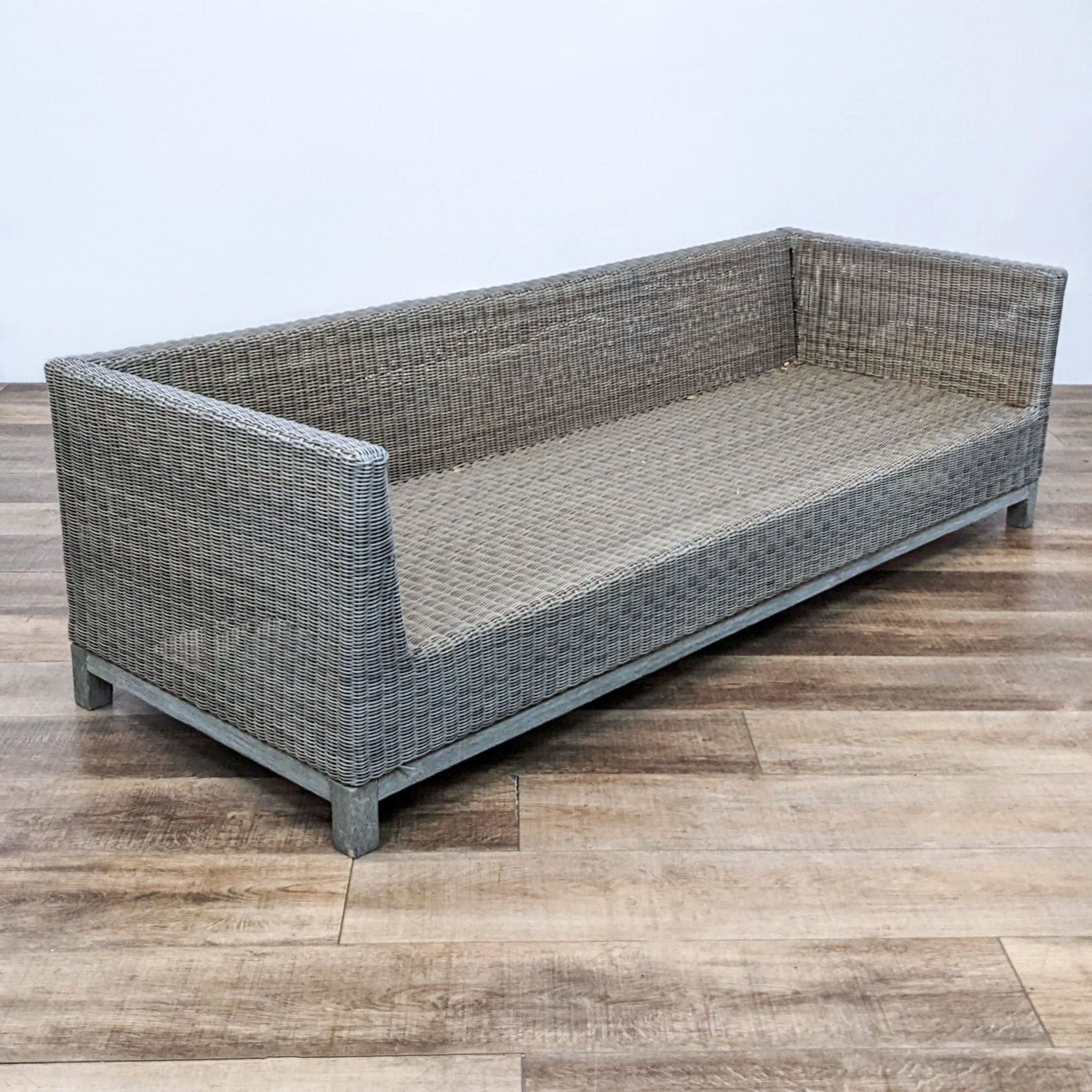 Outdoor 7-foot sofa with a gray resin wicker finish and sturdy wooden frame, designed by Restoration Hardware.