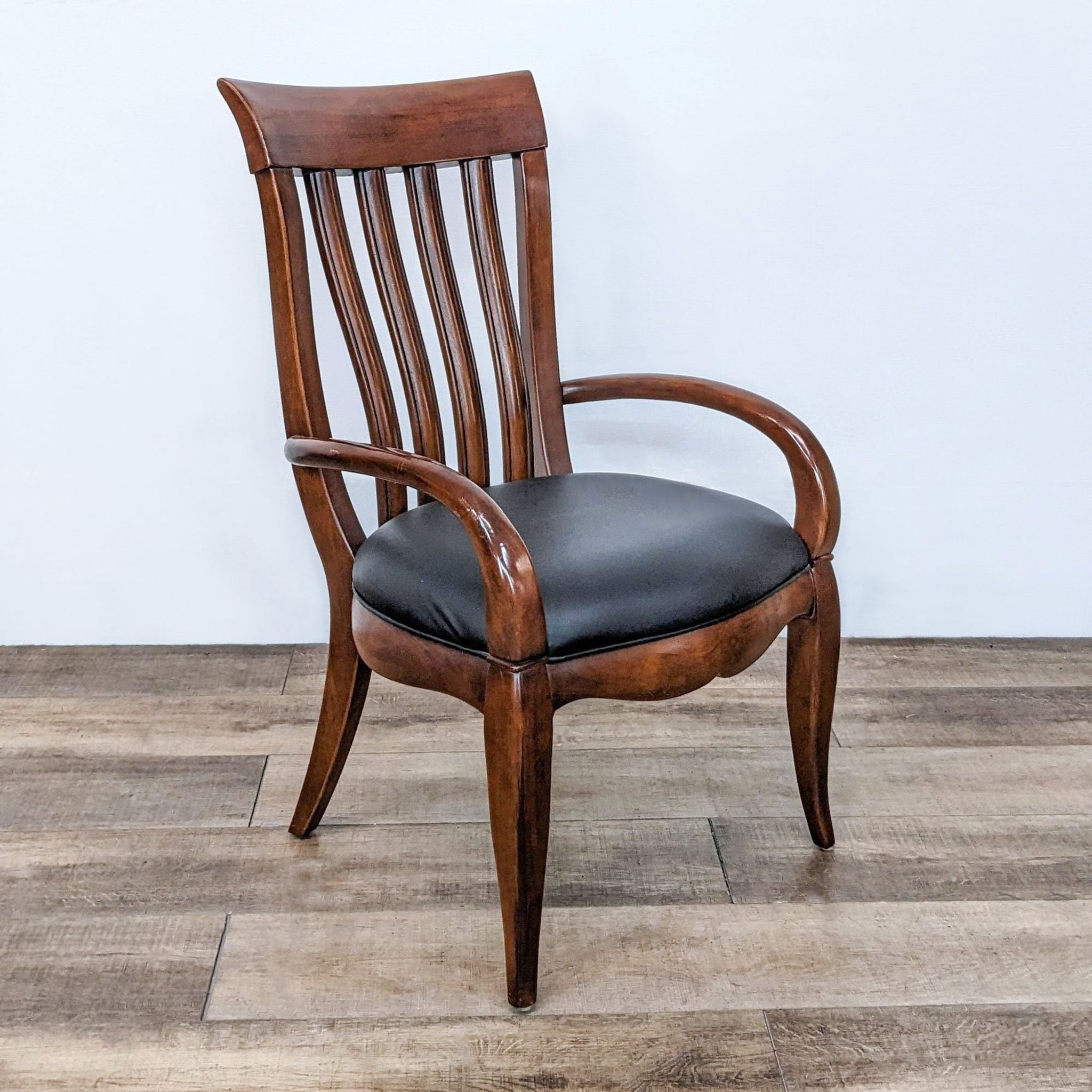 Bernhardt dining chair with vertical slat back design and black leather seat.