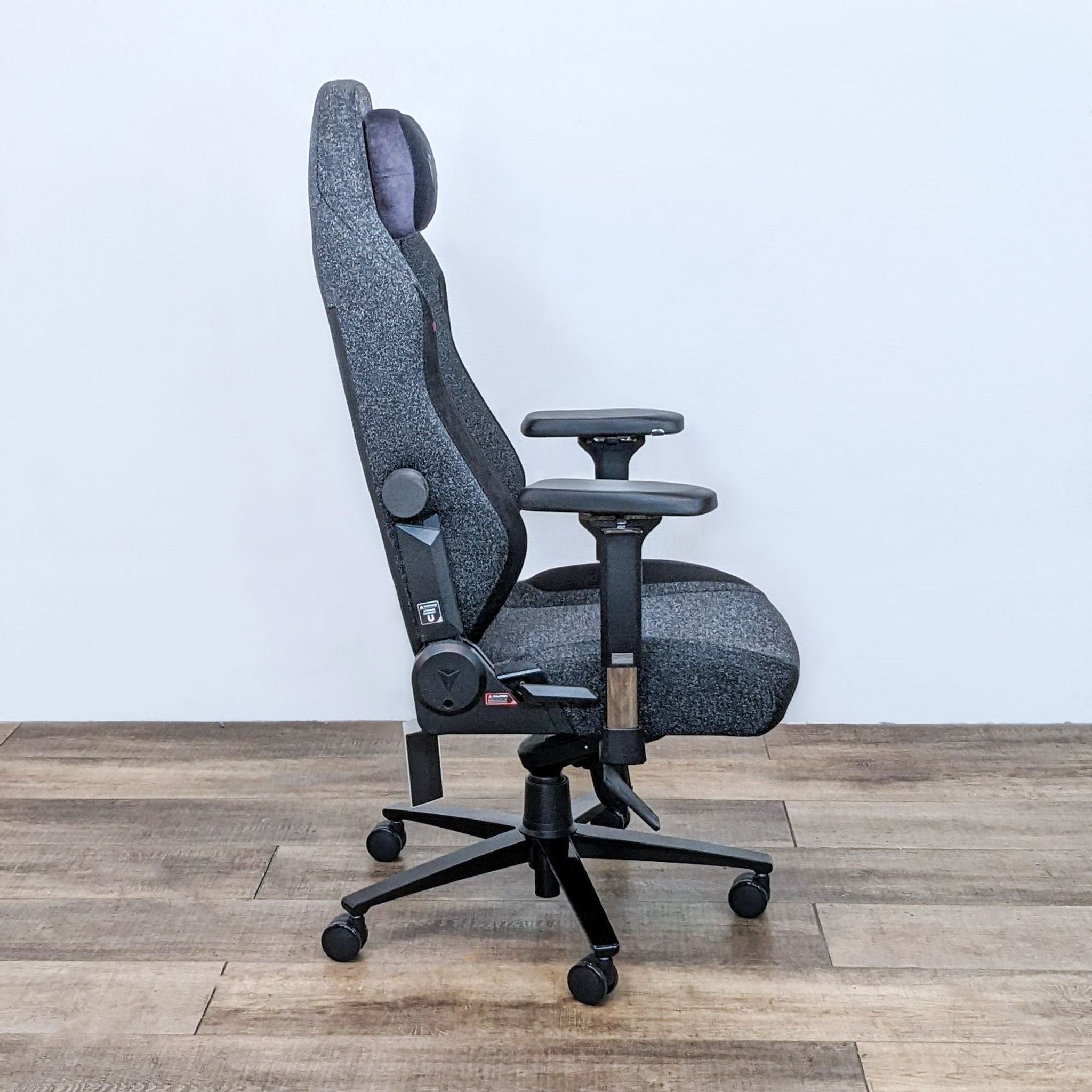 Alt text 2: Side view of a gray Secretlab Titan Evo chair, showcasing its hydraulics and adjustable armrests.