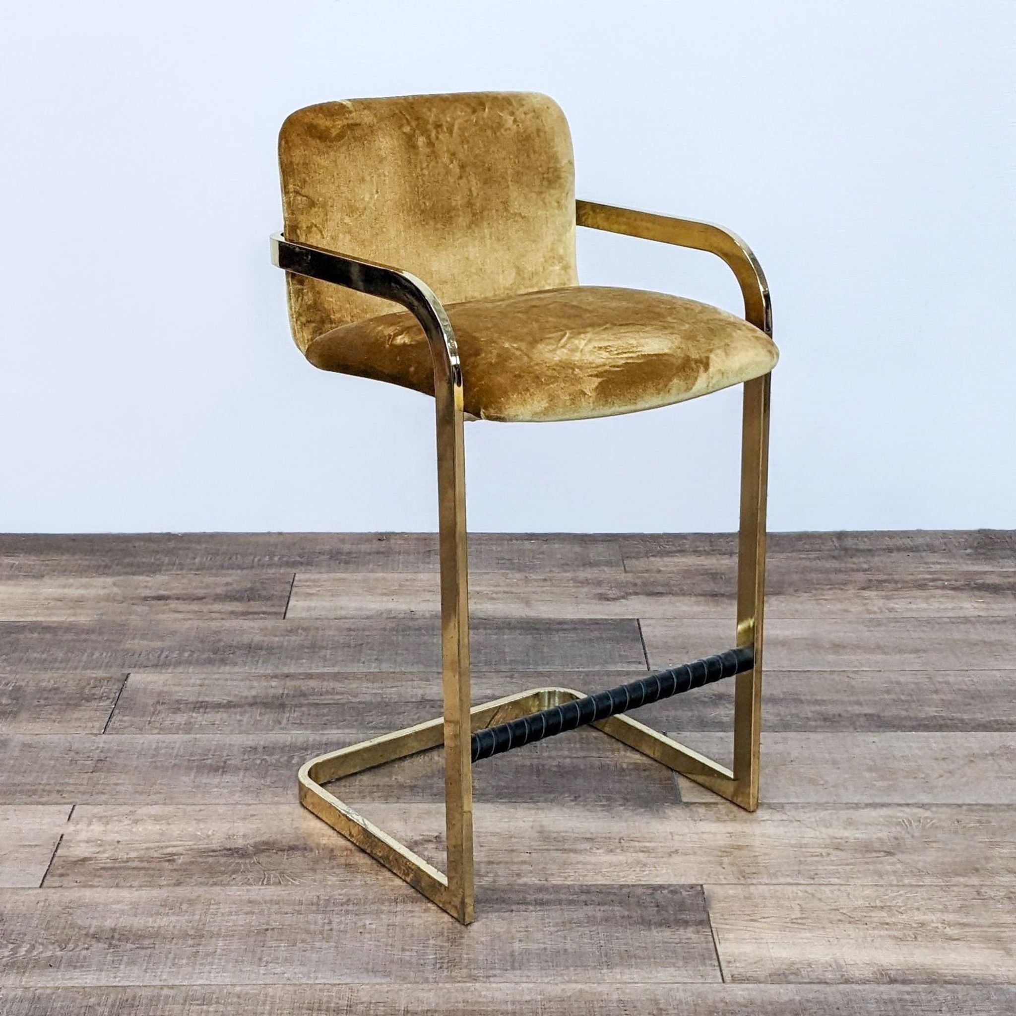 Mid-century designer Milo Baughman stool with padded gold velvet seat and back area, brass arms and frame.