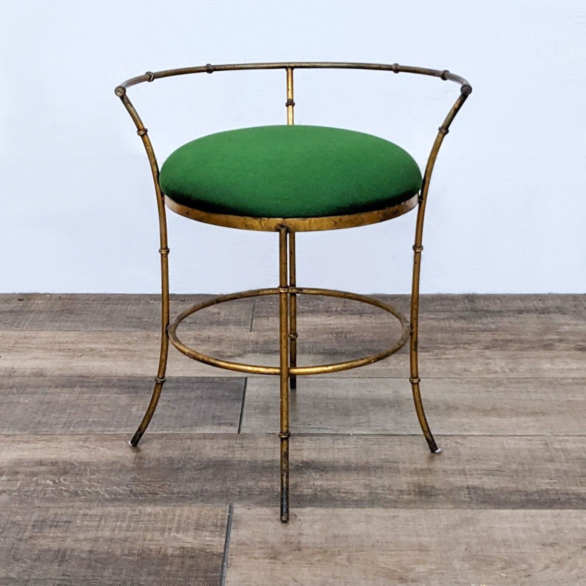 Vintage Gold Color Metal Frame Stool with a green cushioned seat, elegant design, on a wooden floor.