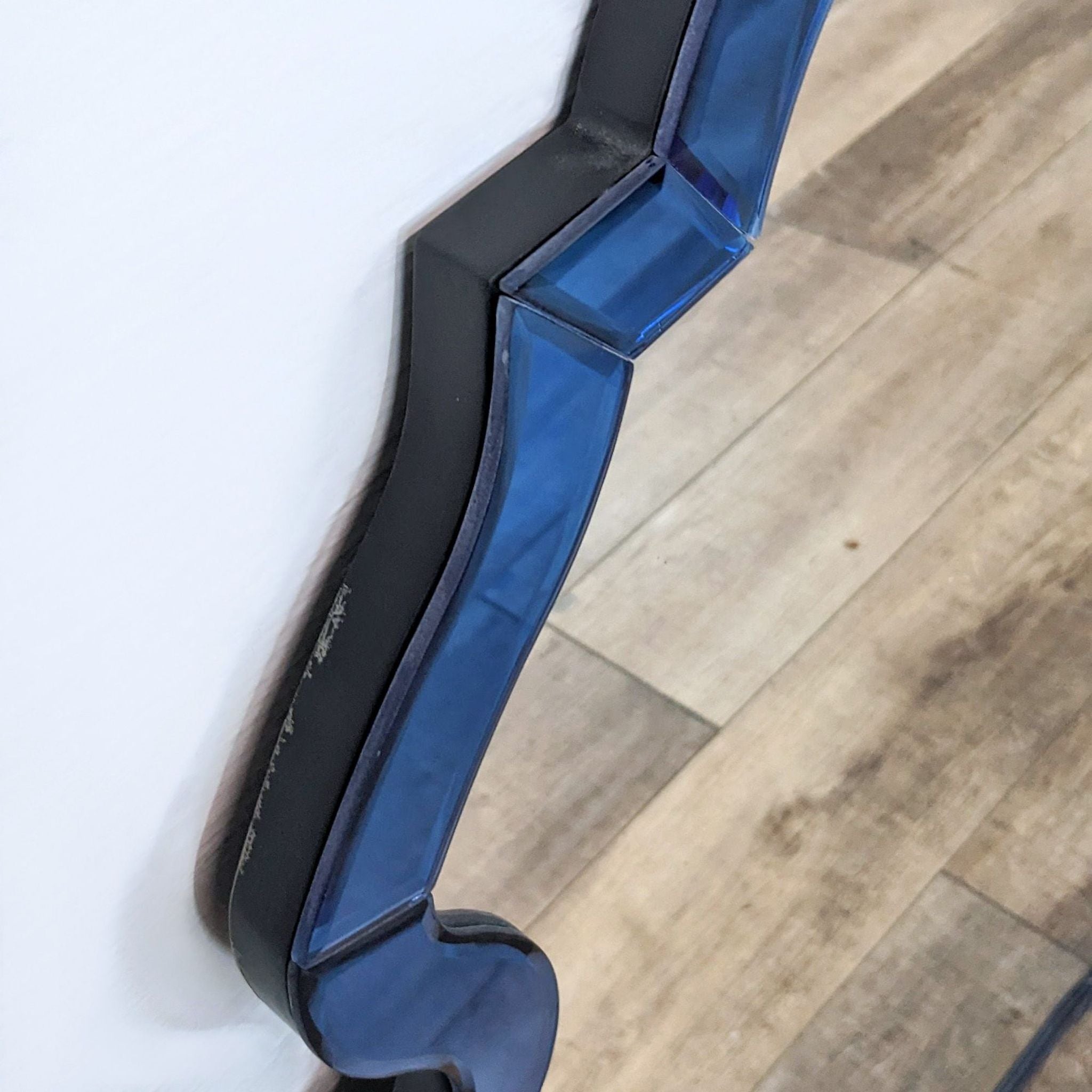 2. Close-up of a blue beveled mirror frame from Mirror Image Home, showcasing the detailed craftsmanship of the beveled edges.