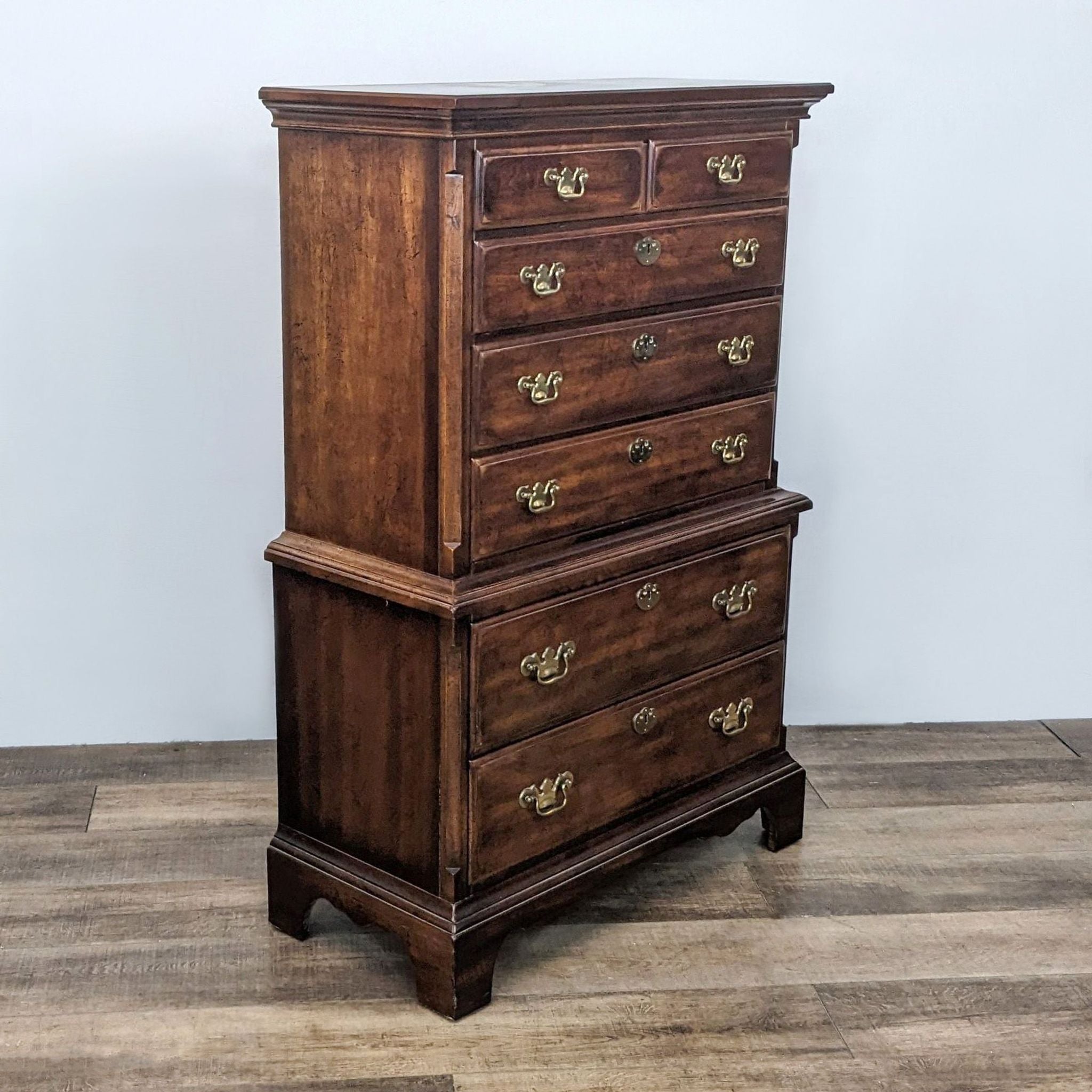 Reperch classic wooden highboy dresser with 6 drawers and antique brass pulls on grey background.